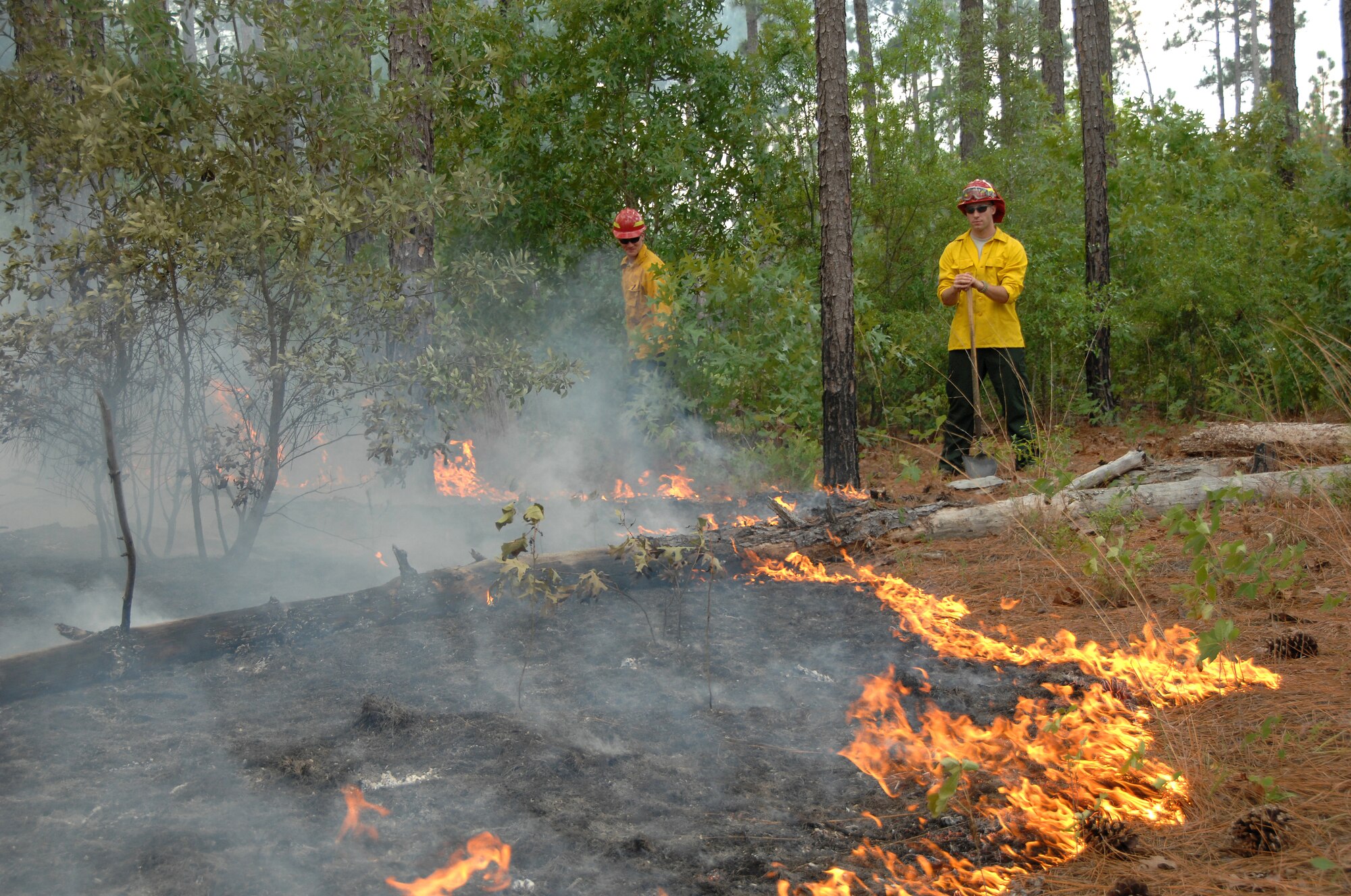 U.S. Air Force Staff Sgt. Chastin Warner and Senior Airman Cody Nelson, 20th Civil Engineer Squadron firefighters, determine the best course of action for extinguishing a fire at Poinsett Electronic Combat Range, S.C., May 21, 2012. Shaw’s firefighters responded quickly to a 150-acre blaze at the Poinsett Range training site. (U.S. Air Force photo by Airman 1st Class Blake Hubbard/Released)
