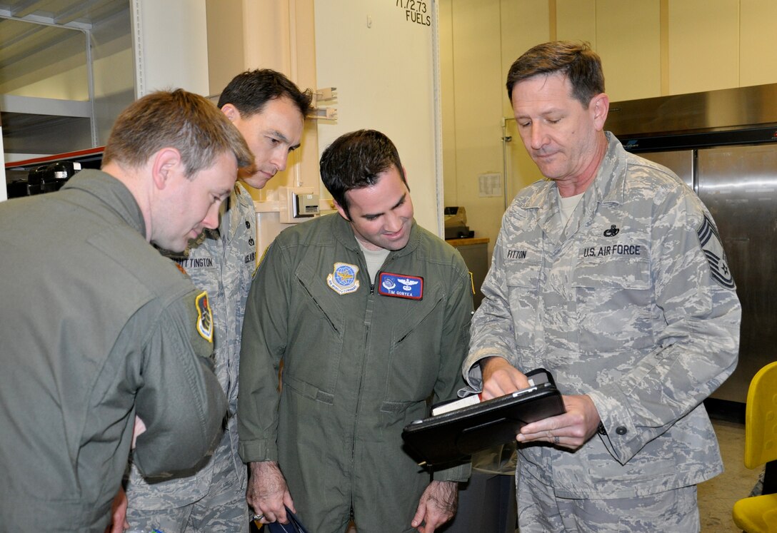 YOKOTA AIR BASE, JAPAN – (Left to right) Majors Erik Brine, Joseph Whittington and Timothy Gonyea, students in the Advanced Study of Air Mobility course, learn about an automated system for tracking maintenance operations from Chief Master Sgt. John Fitton, of the 730th Air Mobility Squadron, during a tour of Air Force Mobility units at Yokota Air Base, May 11. The students applied classroom theory to real world operations as part of the 13-month Master of Science in Logistics program offered at the U.S. Air Force Expeditionary Center. (U.S. Air Force photo by 1st Lt. Sybil Taunton, U.S. Air Force Expeditionary Center public affairs)