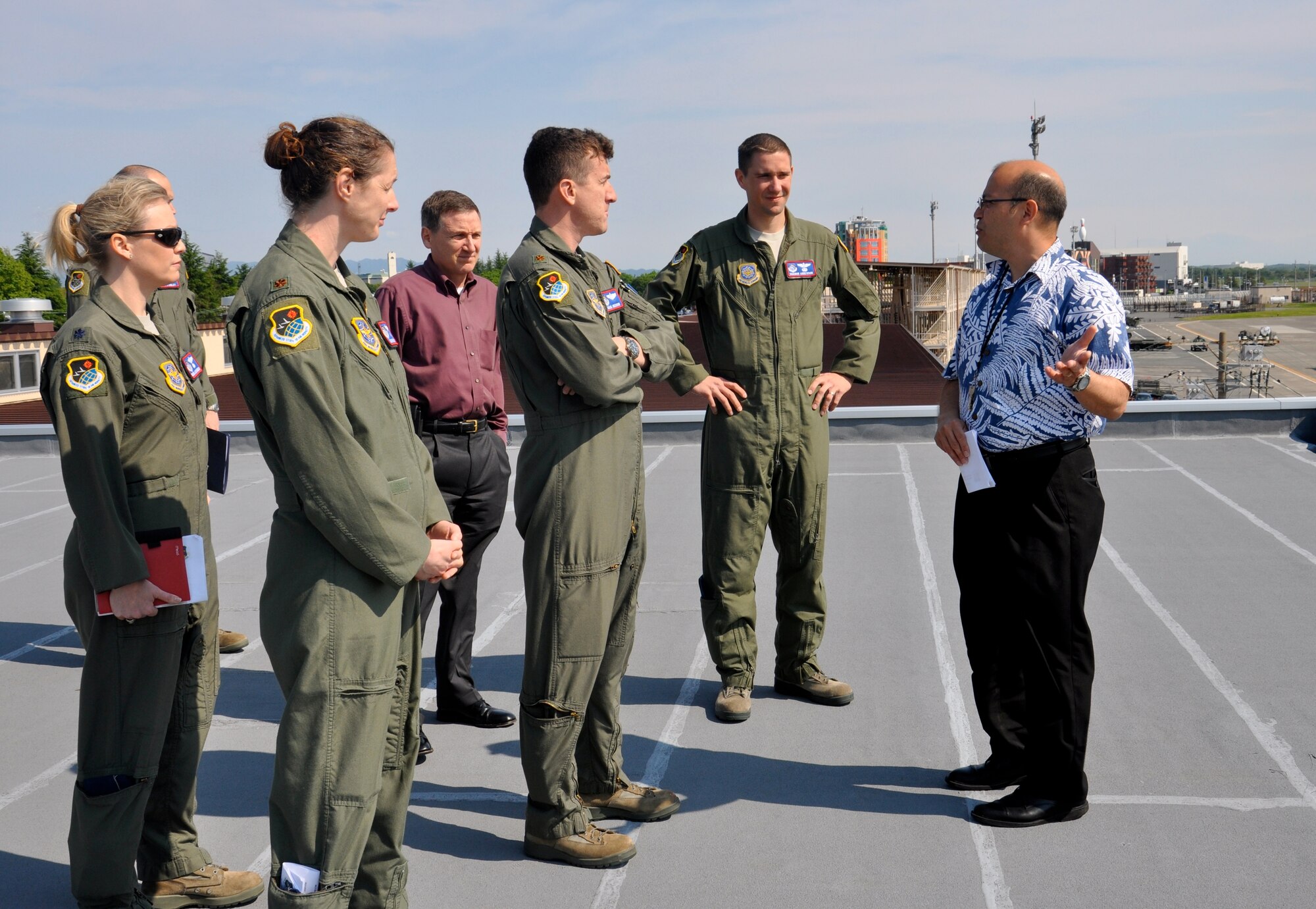 YOKOTA AIR BASE, JAPAN – (Left to Right) Lt. Col. Mona Alexander, Maj. Sarah Lynch, Maj. Mark Oberson, and Maj. Shanon Anderson, Advanced Study of Air Mobility students, along with Mr. Rudy Becker, director of the Mobility Operations School, from the U.S. Air Force Expeditionary Center listen as Mr. Ernie Weber, of the 730th Air Mobility Squadron, discusses upgrades taking place along the flight line, May 11. The students traveled to various locations throughout the Pacific to discuss global mobility and logistics operations after spending 13 months working toward a Master of Science in Logistics degree in the ASAM program. (U.S. Air Force photo by 1st Lt. Sybil Taunton, U.S. Air Force Expeditionary Center public affairs)