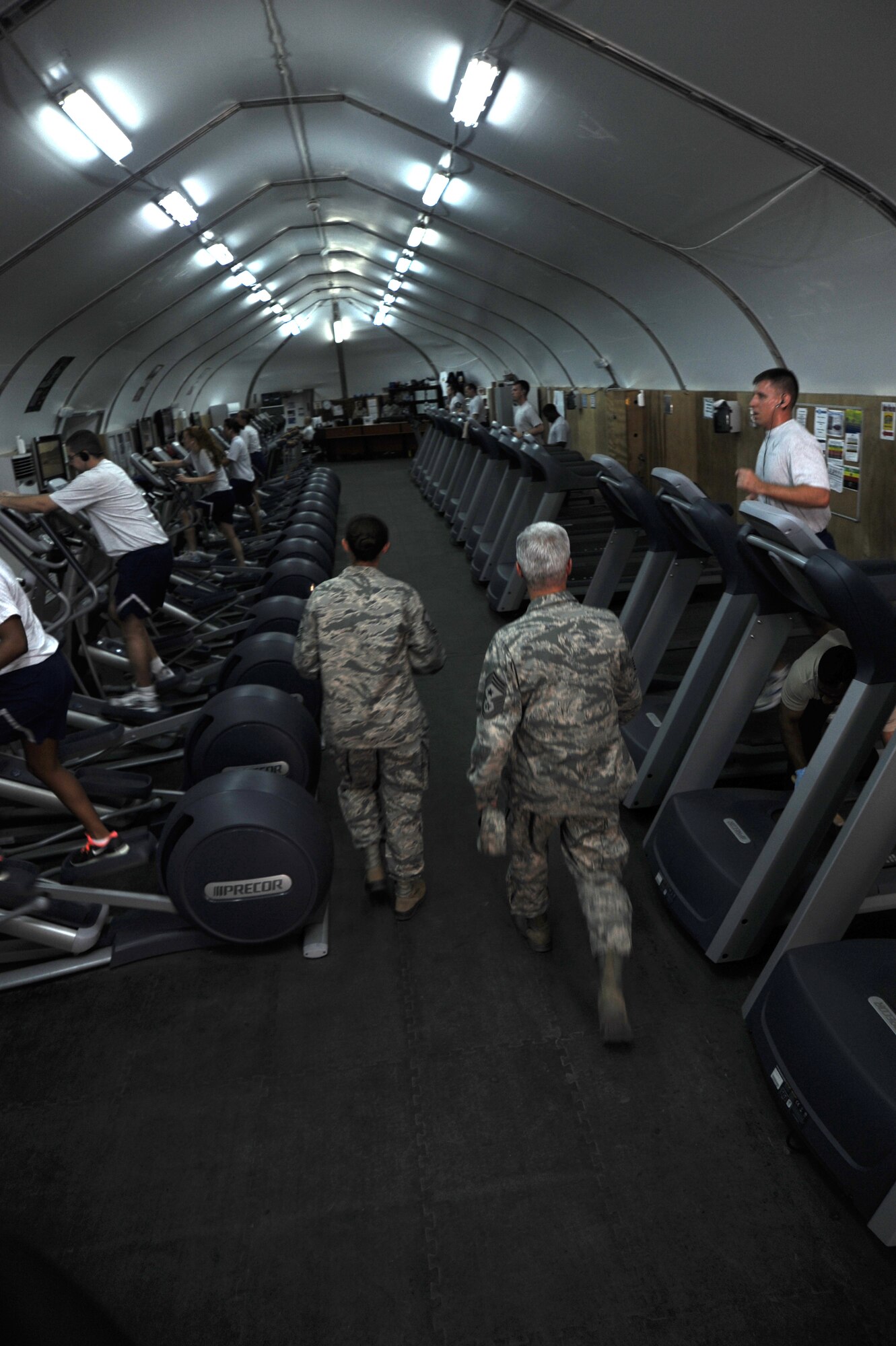 SOUTHWEST ASIA -- Chief Master Sgt. Robert Sealey gets a tour of fitness facilities from Master Sgt. Lauralee Okoniewski May 22, 2012. Sealey, the U.S. Air Forces Central command chief master sergeant, spoke with several groups of Airmen during his two-day visit to the 380th Air Expeditionary Wing. Okoniewski is a Walnut Ridge, Ark., native deployed from Scott Air Force Base, Ill. (U.S. Air Force photo/Staff Sgt. J.G. Buzanowski)