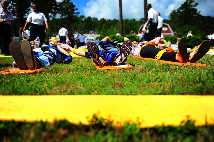 Role players acting as burn victims lay on stretchers while waiting for care during a mass causality exercise May 15, 2012 at the Amenity Center in The Farm at Wescott Plantation. Department of Health and Environmental Control District 7, in conjunction with Joint Base Charleston members, local emergency medical services, fire departments, law enforcement, coroners and all Charleston area hospitals conducted the live, mass causality incident readiness exercise to test first responder abilities and processes.    (U.S. Air Force Photo/Airman 1st Class Jodi Martinez) 