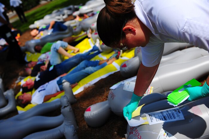 Role players acting as burn victims lay on stretchers while waiting for care during a mass causality exercise May 15, 2012 at the Amenity Center in The Farm at Wescott Plantation. Department of Health and Environmental Control District 7, in conjunction with Joint Base Charleston members, local emergency medical services, fire departments, law enforcement, coroners and all Charleston area hospitals conducted the live, mass causality incident readiness exercise to test first responder abilities and processes.  (U.S. Air Force Photo/Airman 1st Class Jodi Martinez) 