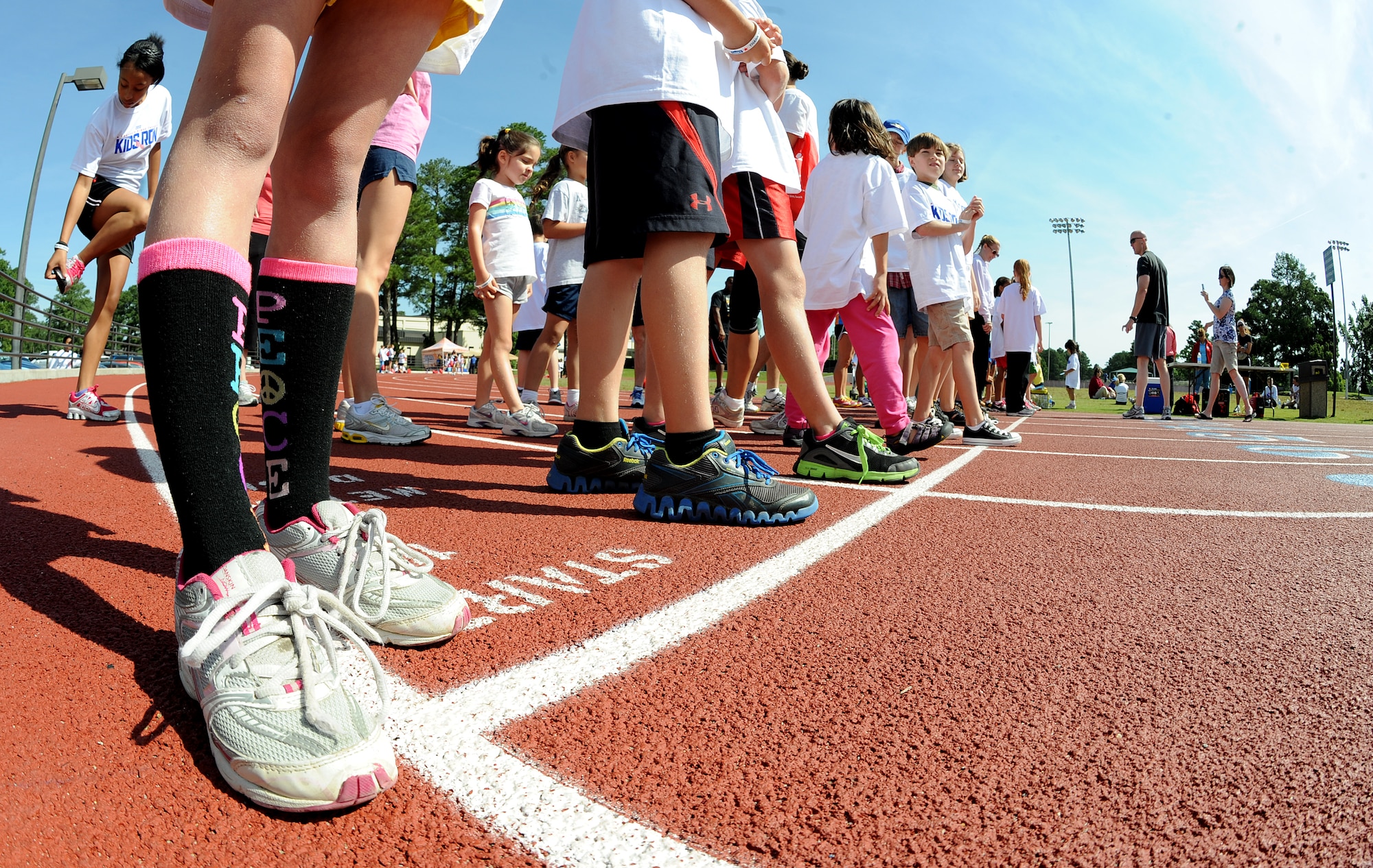 Team Seymour families wait for a one-mile race to begin during the America’s Armed Forces Kids Run event on Seymour Johnson Air Force Base, N.C., May 19, 2012. Families participated in half-mile, one-mile and 5k races as well as bowling and field games. (U.S. Air Force photo/Airman 1st Class Aubrey Robinson/Released)