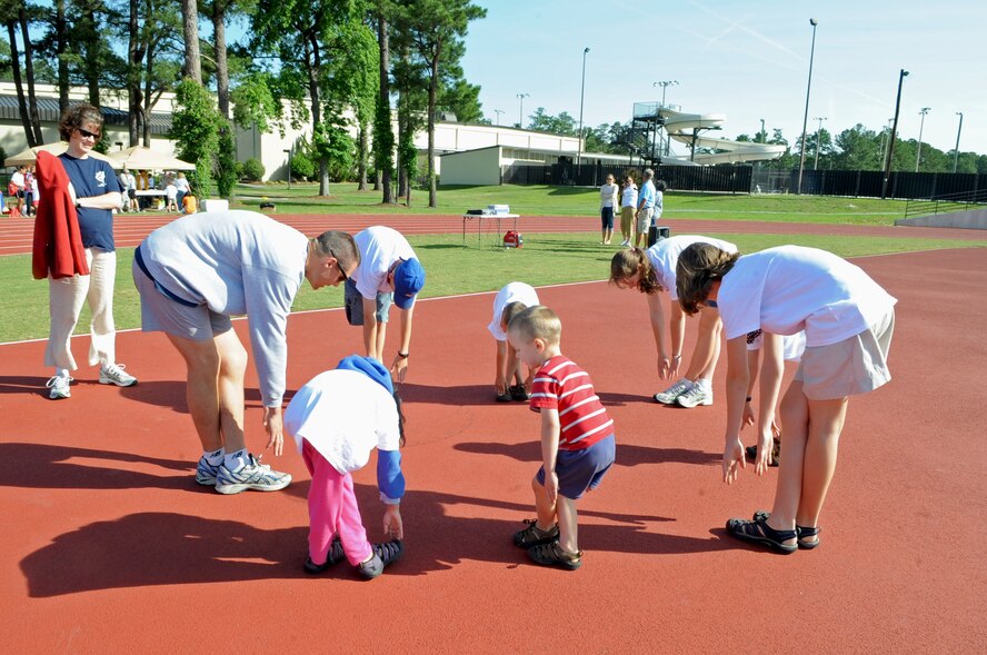 U.S. Air Force Lt. Col. Andrew Muser and his family stretch before the first race begins during the America’s Armed Forces Kids Run event on Seymour Johnson Air Force Base, N.C., May 19, 2012. Many families came out to participate in the races and games as well as to celebrate Armed Forces Day. Muser is the commander of the 4th Civil Engineer Squadron and his family hails from Minnesota. (U.S. Air Force photo/Airman 1st Class Aubrey Robinson/Released)