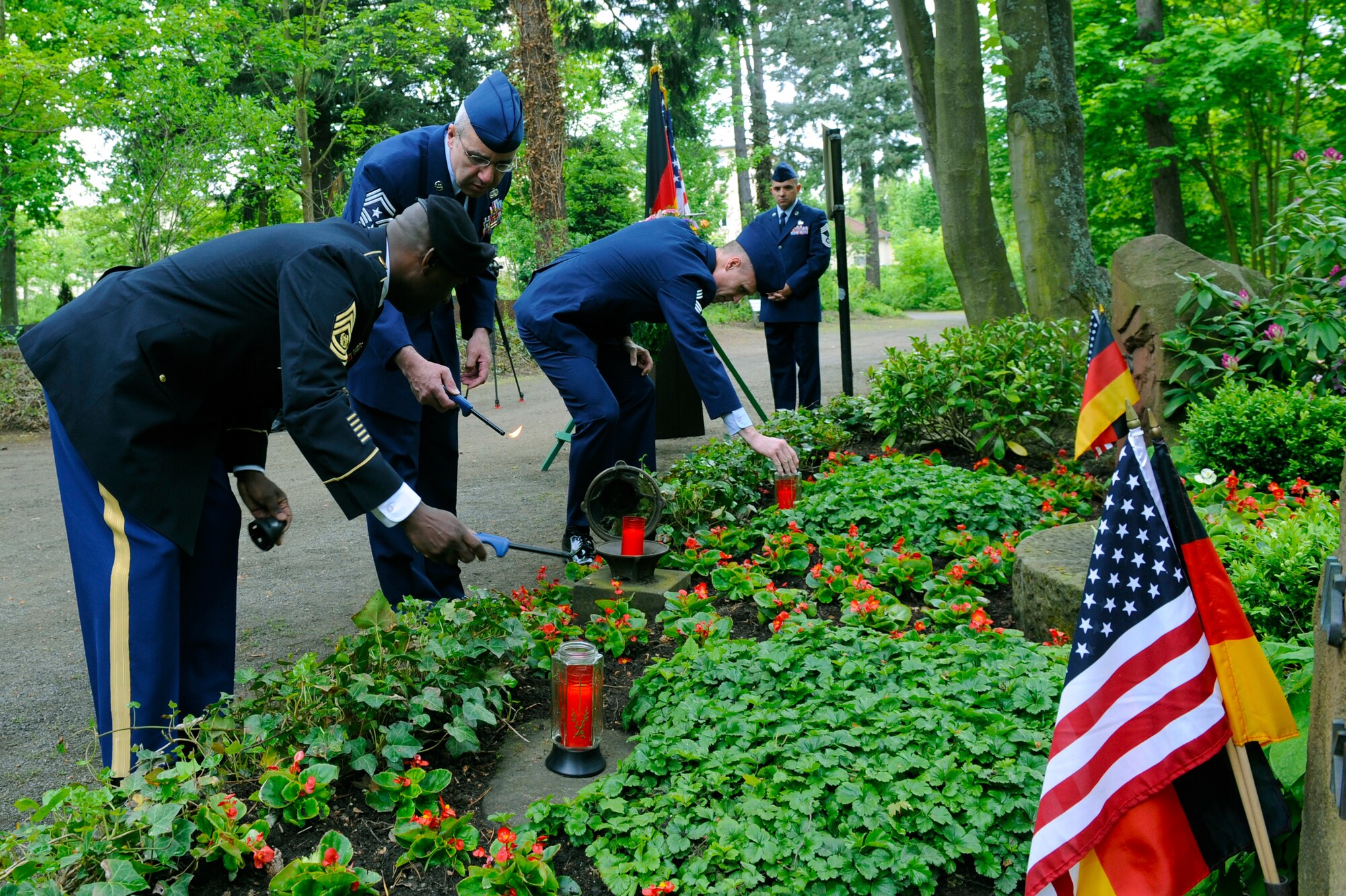 Ramstein area leadership light candles during a ceremony at the Kinder graves memorial, Kaiserslautern, Germany, May 19, 2012.The memorial service is held annually the week following Mother's Day to honor the children who weren't able to be buried in America. (U.S. Air Force photo/Senior Airman Aaron-Forrest Wainwright)