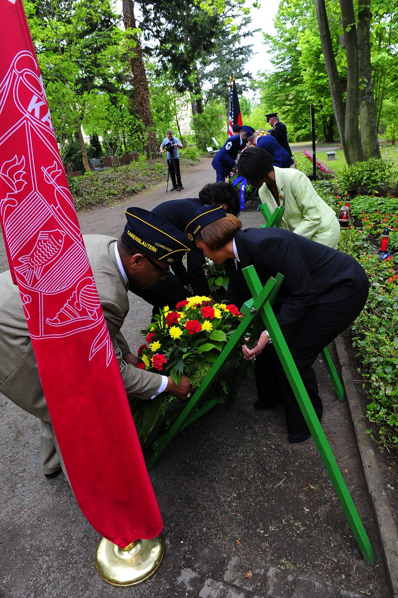 Ramstein area leadership lift wreathes during a ceremony at the Kinder graves memorial, Kaiserslautern Germany, May 19, 2012.The memorial service is held annually the week following Mother's Day to honor the children who weren't able to be buried in America. (U.S. Air Force photo/Senior Airman Aaron-Forrest Wainwright)
