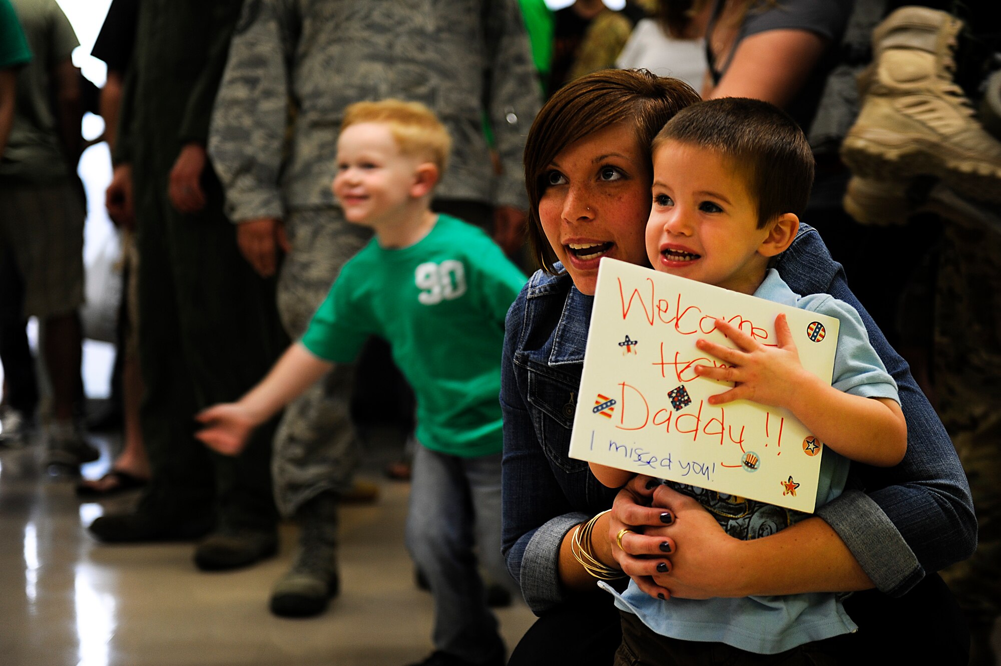 Katie Rynrandt, and her son, Drew, wait to greet U.S. Air Force 1st Lt. Kevin Rynbrandt, 33rd Rescue Squadron HH-60 Pave Hawk helicopter pilot, during a homecoming for the 33rd RQS and 718th Aircraft Maintenance Squadron on Kadena Air Base, Japan, May 20, 2012. Rynbrandt returned May 20 after a four-month deployment to Bagram Air Field, Afghanistan. (U.S. Air Force photo/Airman 1st Class Maeson L. Elleman)