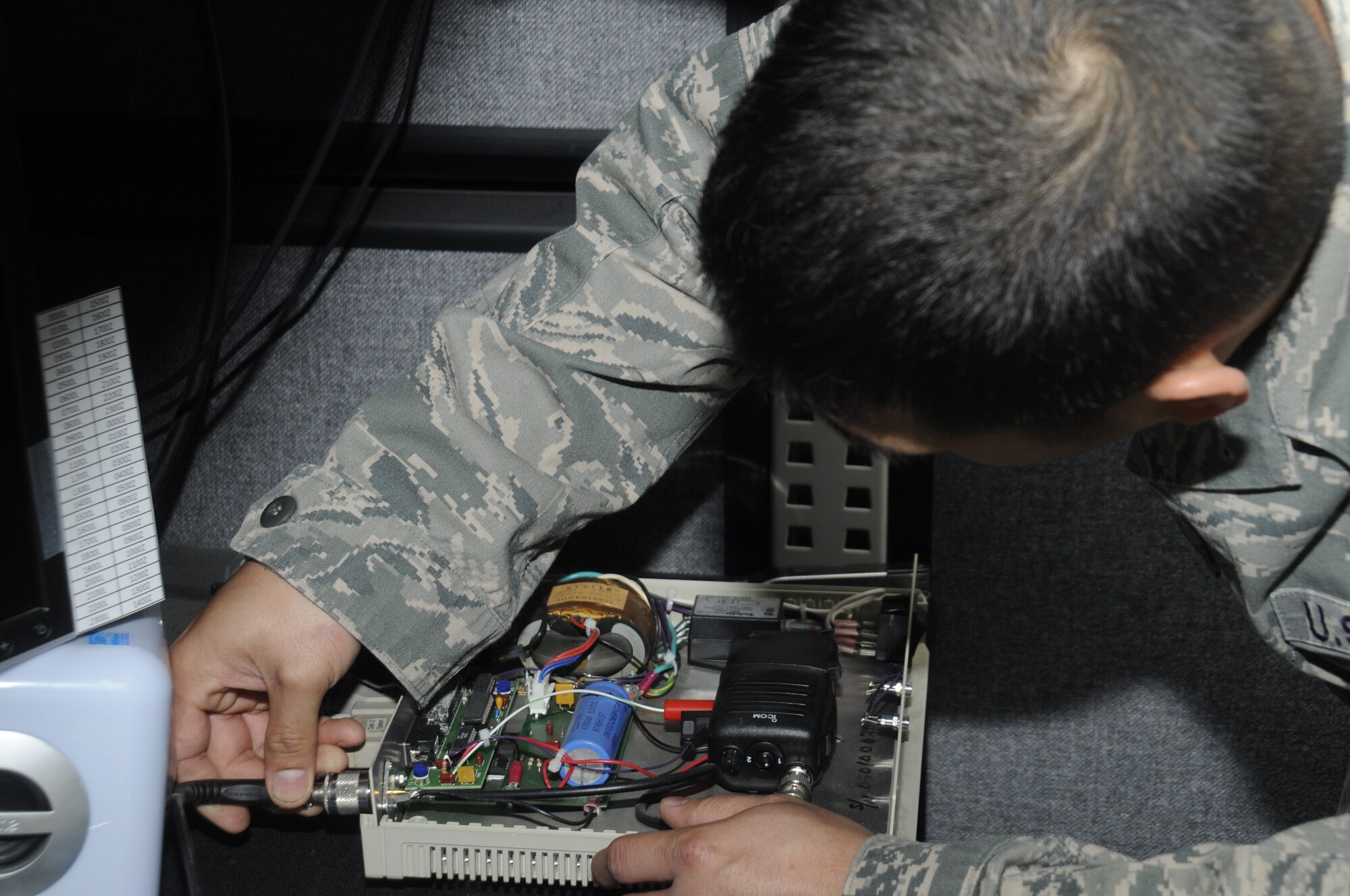 Staff Sgt. Leo Angelo Mangahas, 35th Communication Squadron personal wireless communication systems NCO in charge, works on a radio control box at Misawa Air Base, Japan, May 22, 2012. The box is used to send signals to one or all of the bird aircraft strike-hazard cannons located on the base’s flightline. (U.S. Air Force photo by Airman 1st Class Zachary Kee/ Released)