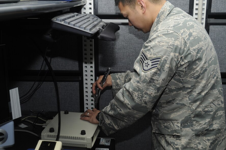 Staff Sgt. Leo Angelo Mangahas, 35th Communication Squadron personal wireless communication systems non-commissioned officer in charge, opens a radio control box at Misawa Air Base, Japan, May 22, 2012. The PWCS shop on base is responsible for issuing, encrypting and repairing a $6 million inventory. The inventory includes handheld radios, base stations and other portable wireless communication devices. (U.S. Air Force photo/Airman 1st Class Zachary Kee/Released) 
