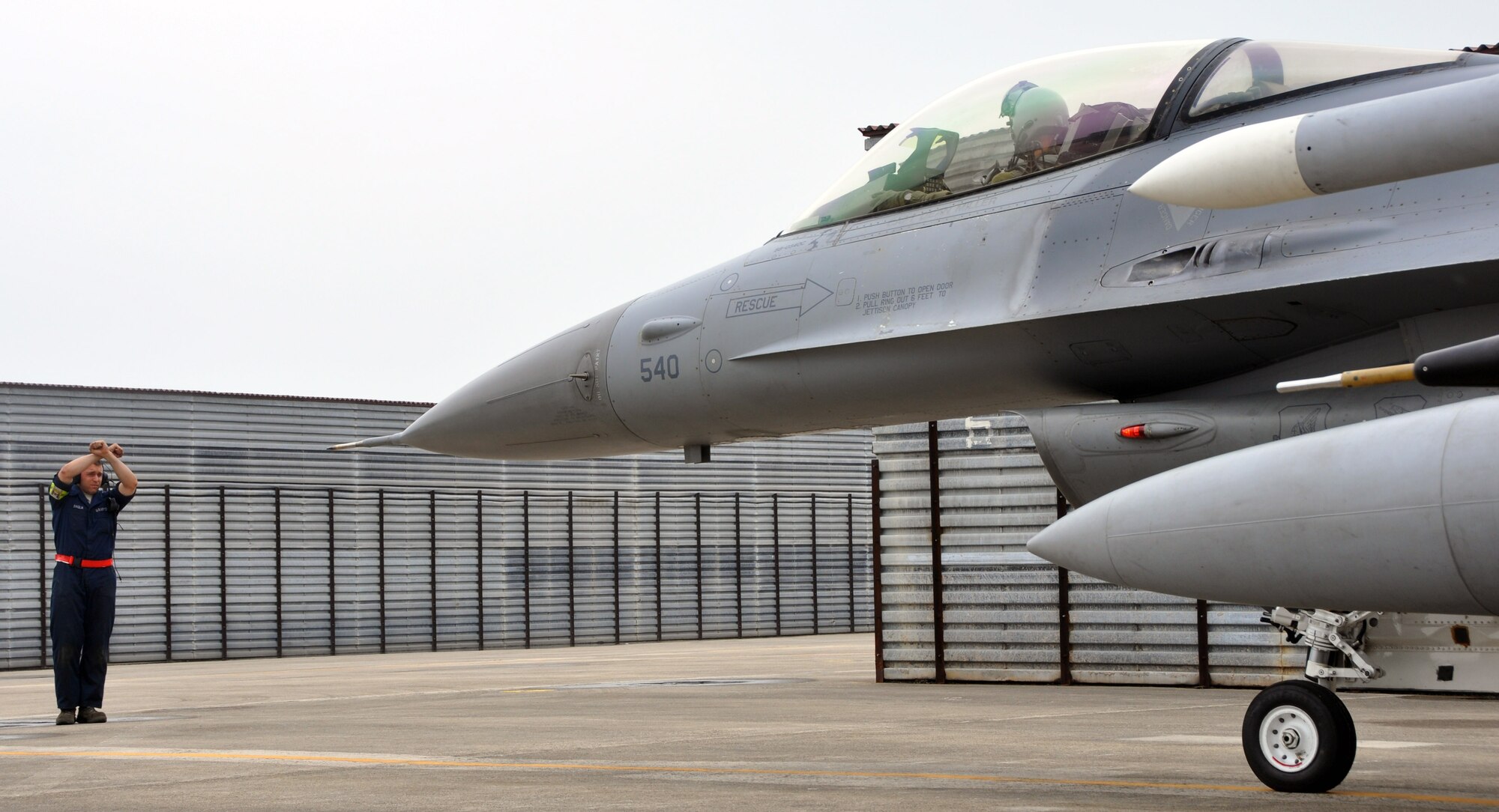 Airman 1st Class Kyle Baglia, 36th Aircraft Maintenance Unit F-16 crew chief, signals Lt. Col. John Seuell, to stop at a parking spot at Gwangju Air Base, Republic of Korea, May 16, 2012.  Approximately 720 U.S. and ROKAF Airmen deployed to Gwangju Air Base in support of joint exercise Max Thunder 12-1. Seuell is the 36th Fighter Squadron commander. (U.S Air Force photo/Airman 1st Class Michael Battles)