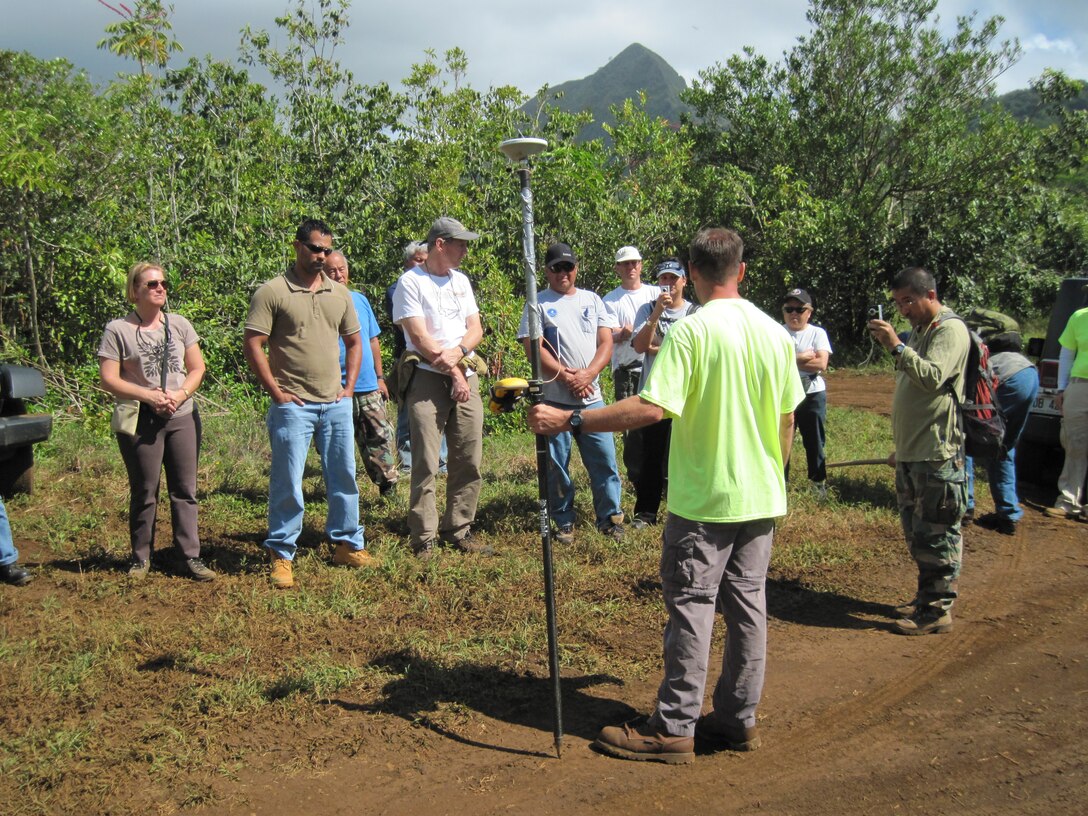 Dwayne French of Zapata Inc. provides a demonstration on the Remedial Investigation/Feasibility Study process during a site visit to the Waikane Valley FUDS project.
