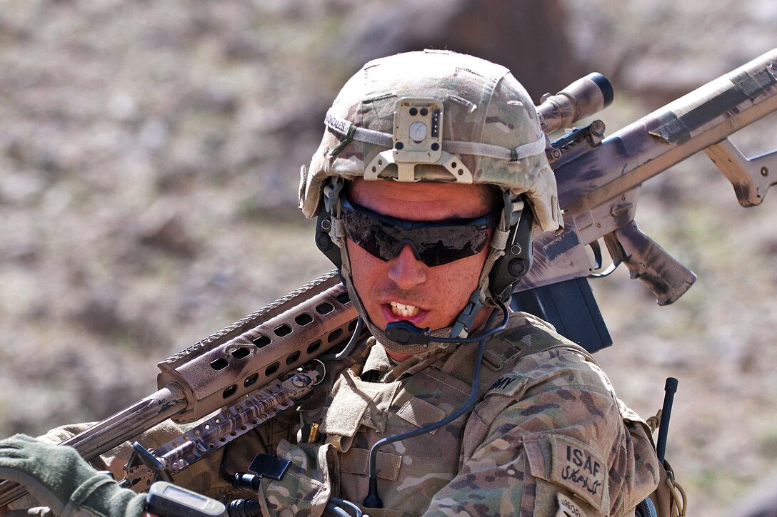 U.S. Army Sgt. Kyle Gonzales talks over a field radio while on patrol in Afghanistan's Ghazni province, May 19, 2012. Gonzales, a sniper, is assigned to the 82nd Airborne Division’s 3rd Squadron, 73rd Cavalry Regiment, 1st Brigade Combat Team.