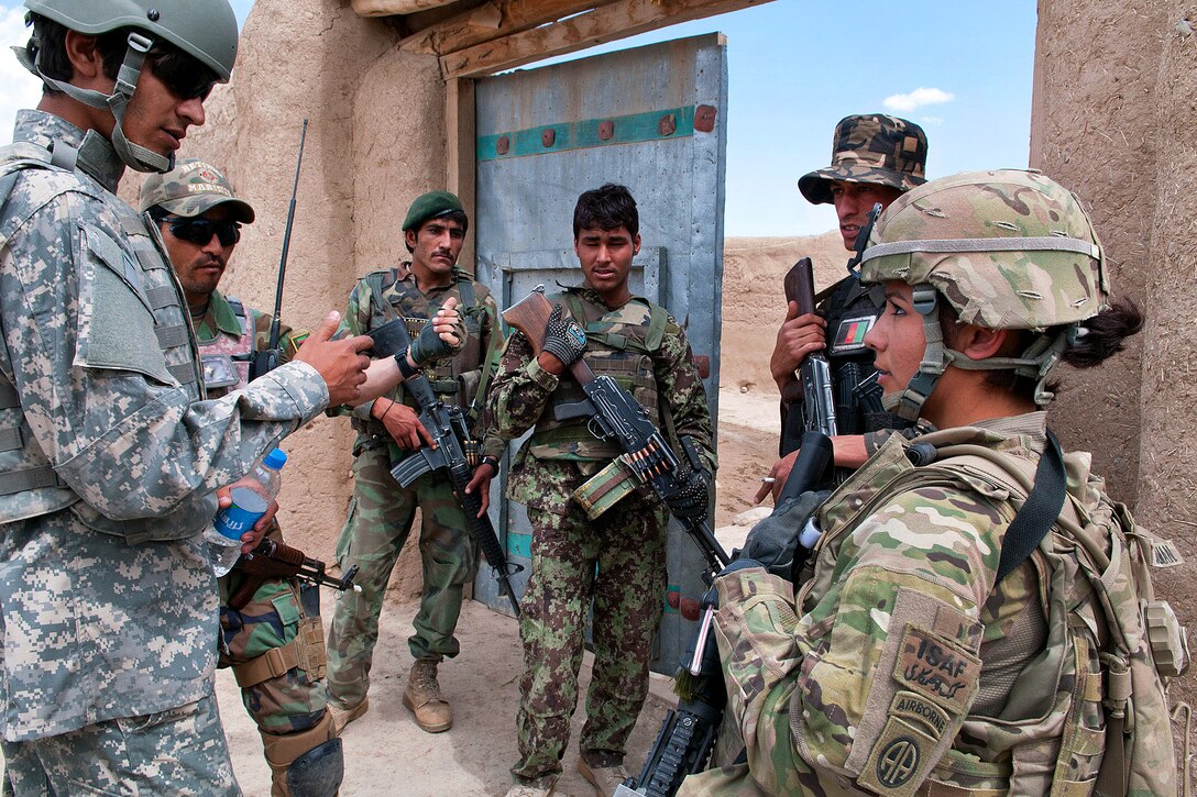 U.S. Army Pfc. Olivia Guzmantejeda asks to meet with Afghan women during a combined patrol in Afghanistan's Ghazni province, May 19, 2012. Guzmantejeda is assigned to the 82nd Airborne Division’s 3rd Squadron, 73rd Cavalry Regiment, 1st Brigade Combat Team.