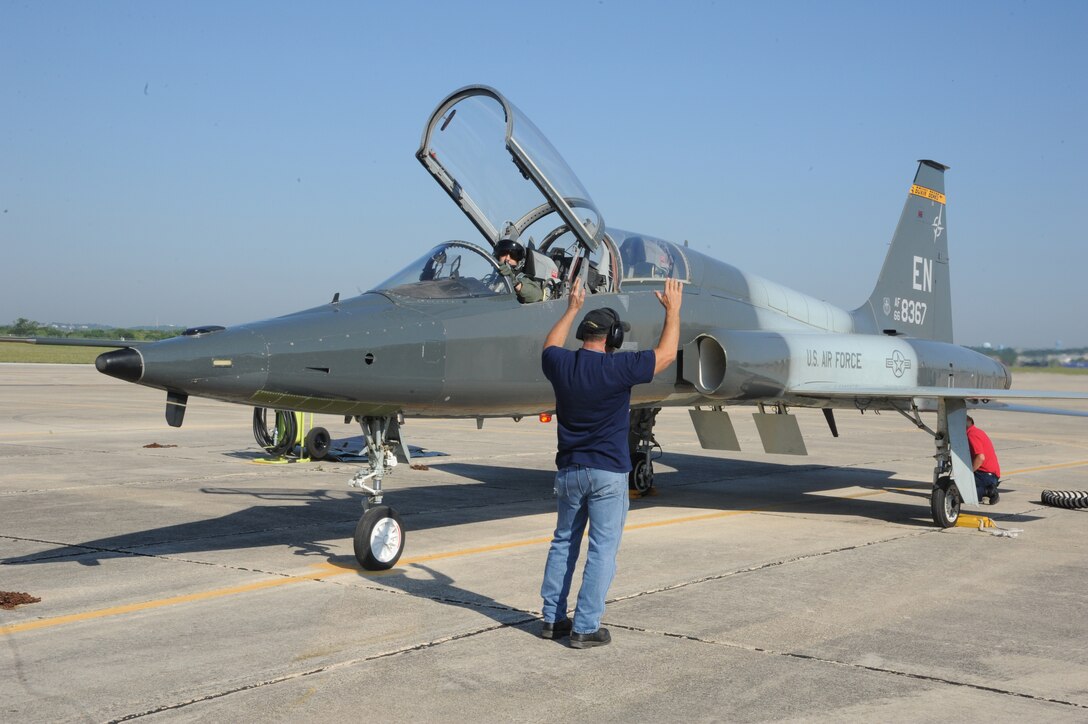 Keith Barnes, 571st Aircraft Maintenance Squadron contractor, performs final checks to the T-38 Talon prior to Lt. Col. Ripley Woodard, 415th Flight Test Flight commander, taking off from Joint Base San Antonio-Randolph, Texas May 17. The T-38 is being returned to Sheppard Air Force Base, Texas, after being modified by the 571st here. (U.S. Air Force photo by Rich McFadden) 