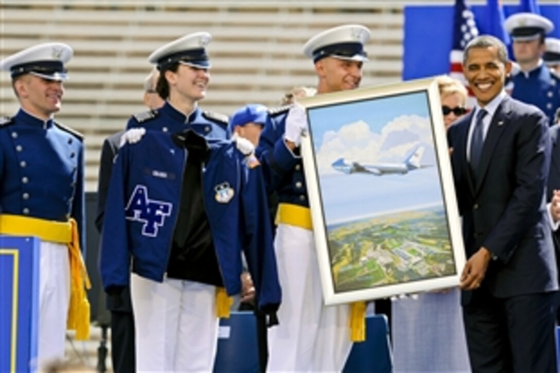 President Barack Obama receives a gift from senior ranking cadets after delivering the commencement address to the U.S. Air Force Academy's class of 2012 at the academy in Colorado Springs, Colo., May 23, 2012.