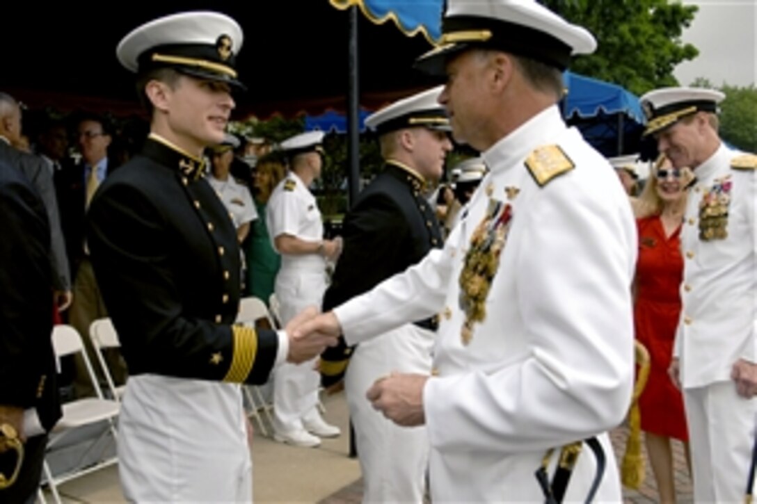 Navy Adm. James A. Winnefeld Jr., vice chairman of the Joint Chiefs of Staff, right, congratulates a midshipman on his performance during the color parade at the U.S. Naval Academy in Annapolis, Md., May 23, 2012. Winnefeld attended the event with his father, retired Rear Adm. James A. Winnefeld  Sr., a 1951 Naval Academy graduate who later became commandant of  midshipmen.
