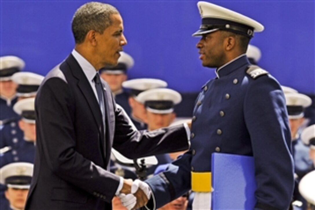 President Barack Obama congratulates Air Force Cadet 1st Class Timothy Jefferson on graduating from the U.S. Air Force Academy during the graduation ceremony at the academy in Colorado Springs, Colo., May 23, 2012. Jefferson was the starting quarterback for the Air Force Falcons football team.