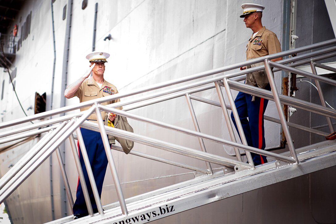 Col. Kenneth M. DeTreux, commanding officer, Special Purpose Marine-Air Ground Task Force - New York, salutes the American flag as he departs the USS Wasp in New York to commemorate the beginning of Fleet Week New York. Fleet Week is an opportunity for Marines, sailors and coast guardsmen to show the people of New York who the Navy, Marine and Coast Guard team are, what they do, and how committed they are to servint this country. Twenty-one U.S. and coalition ships and more that 6,000 troops will participate in the 25th anniversary of Fleet Week New York, a celebration of the Bicentennial of the War of 1812, May 23 - 30.