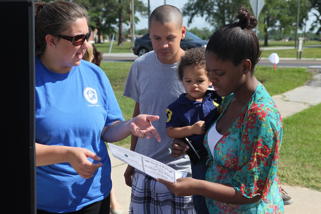 Jesey McManus, a volunteer caseworker with the Navy-Marine Corps Relief Society, speaks with guests of the society's 70th birthday celebration at the NMCRS office aboard Marine Corps Base Camp Lejeune, May 9. The event offered free lunch and dessert to base patrons as a way to increase awareness about the availability of assistance from NMCRS for Marines, sailors and families. 