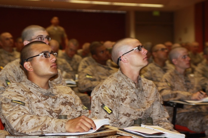 Company G recruits listen to their instructor about Marine Corps history. These classes give recruits and understanding of where the Marine Corps has gone and what it has done. They are given many opportunities to study, both with their drill instructors and on their own. Recruits must pass exams given on this knowledge in order to become Marines. 