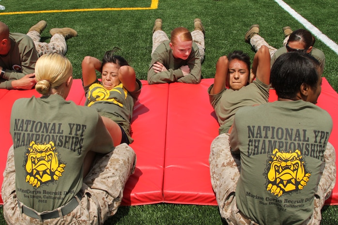 Amanda Llamas (left) and Mirna Hernandez (right), students at United South High School in Laredo, Texas perform sit-ups during the female portion of the National Youth Physical Fitness Championships aboard Marine Corps Recruit Depot San Diego May 18 as Marines encourage them to keep perform more repetitions. More than 150 high school students across the country participated in the five-event competition which included sit-ups, push-ups, pull-ups and a shuttle run. This is the 22nd year MCRD San Diego has hosted the event which is sponsored by the United States Marines Youth Foundation. 'Our goal is to foster fitness in our youth,' said Laurel Hull, NYPF meet director and a retired Marine officer. 'These kids are athletes in the finest sense of the word - for many of them, coming to San Diego for this (competition) is the highlight of their year. They have shown a lot of dedication to prepare for this and so have their coaches.' Hull added that by participating in extracurricular activities like these, young men and women are more likely to live more active and drug-free lives.