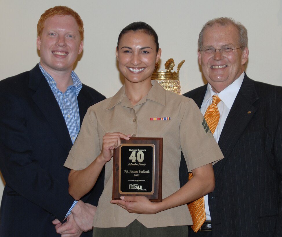 Sgt. JoAnna Sudduth, center, defense chief, Office of the Staff Judge Advocate, Marine Corps Logistics Base Albany, receives an award for being selected as one of Southwest Georgia's 40 under 40, during a ceremony held at Doublegate Country Club, May 4.