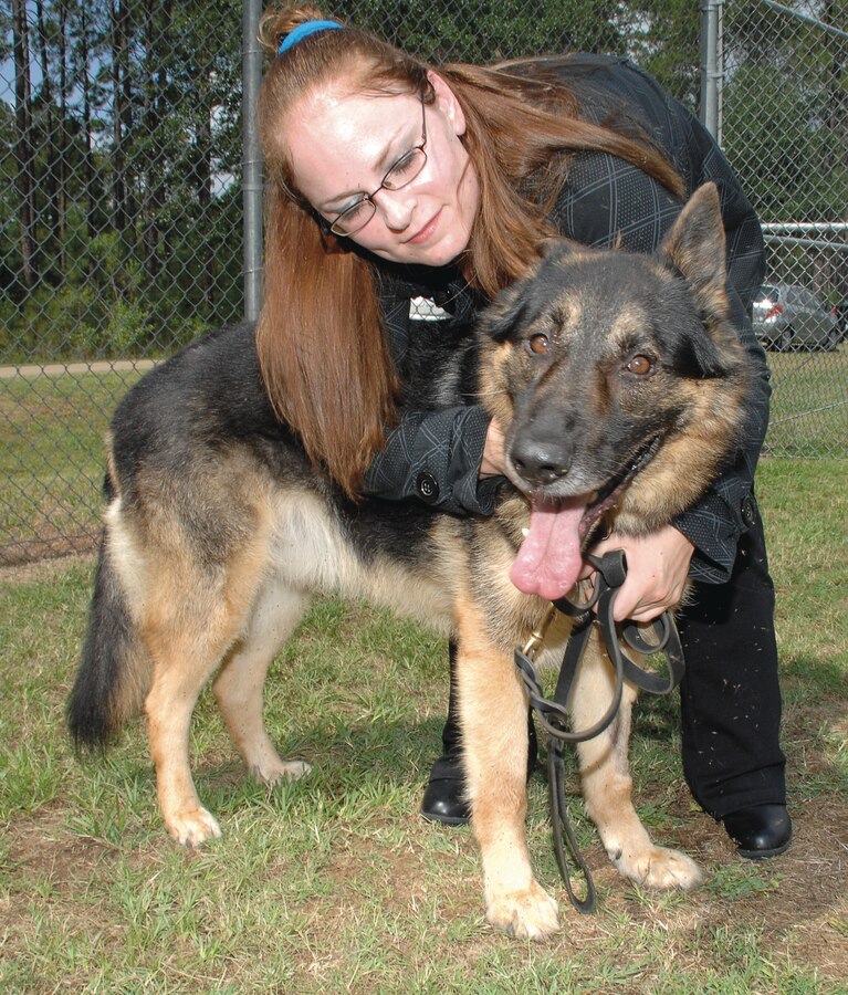 Monique Evangelista hugs her newly-adopted family member, Kastor, a military working dog, at the Corporal Dustin Jerome Lee Kennel aboard Marine Corps Logistics Base Albany, May 14.