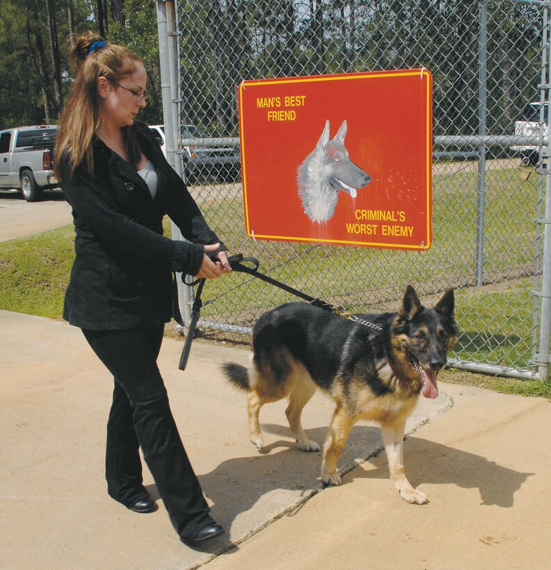 Monique Evangelista walks Kastor, a military working dog, through the gates of the Corporal Dustin Jerome Lee Kennel, May 14.