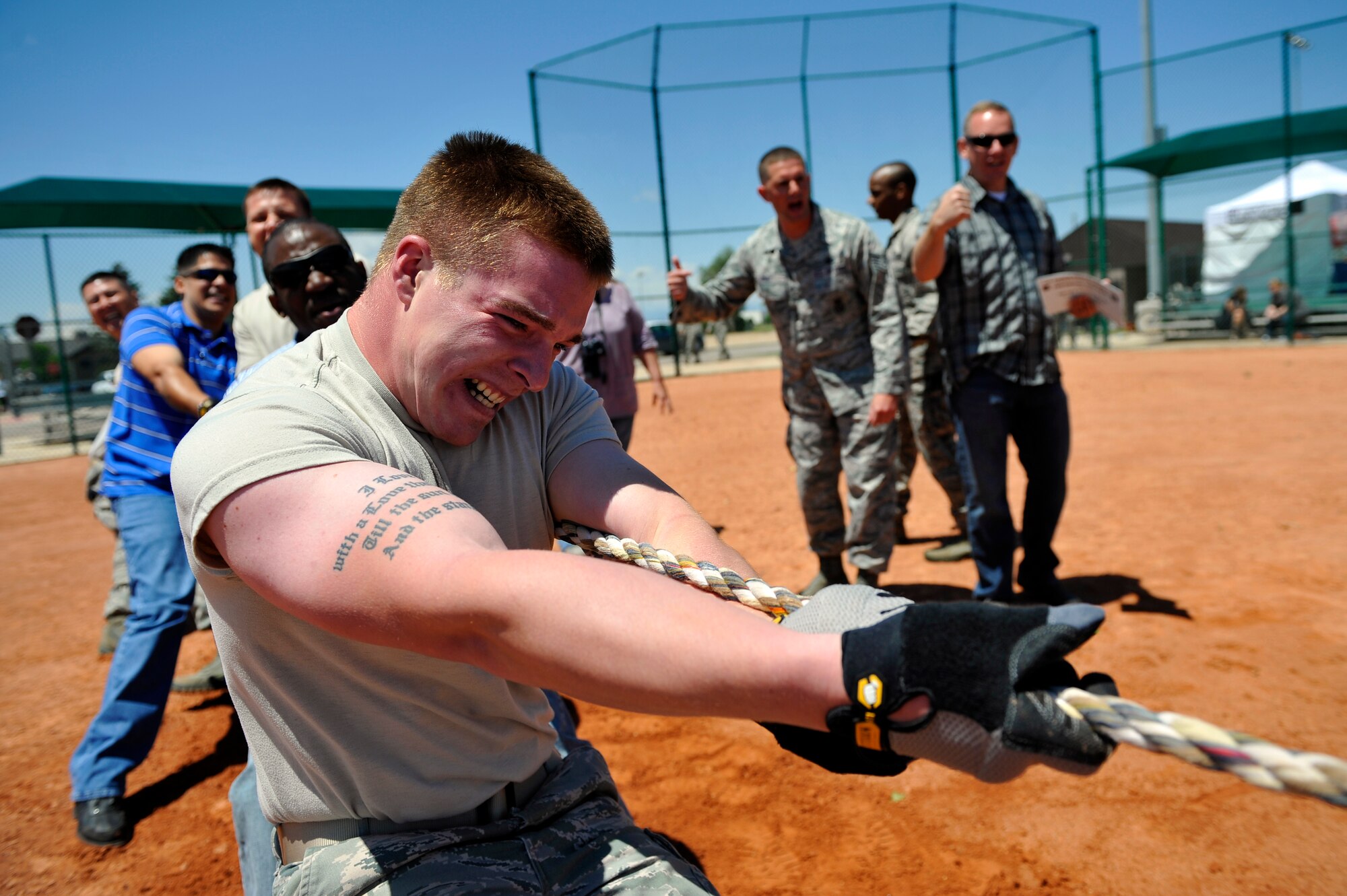 BUCKLEY AIR FORCE BASE, Colo. -- Airman 1st Class Shawn Lamb, 460th Space Wing Security Forces Squadron, pulls with his team during a tug-of-war competition May 24, 2012. Lamb and his team won their first match against 460th SW Wing Staff. (U.S. Air Force photo by Staff Sgt. Kathrine McDowell)