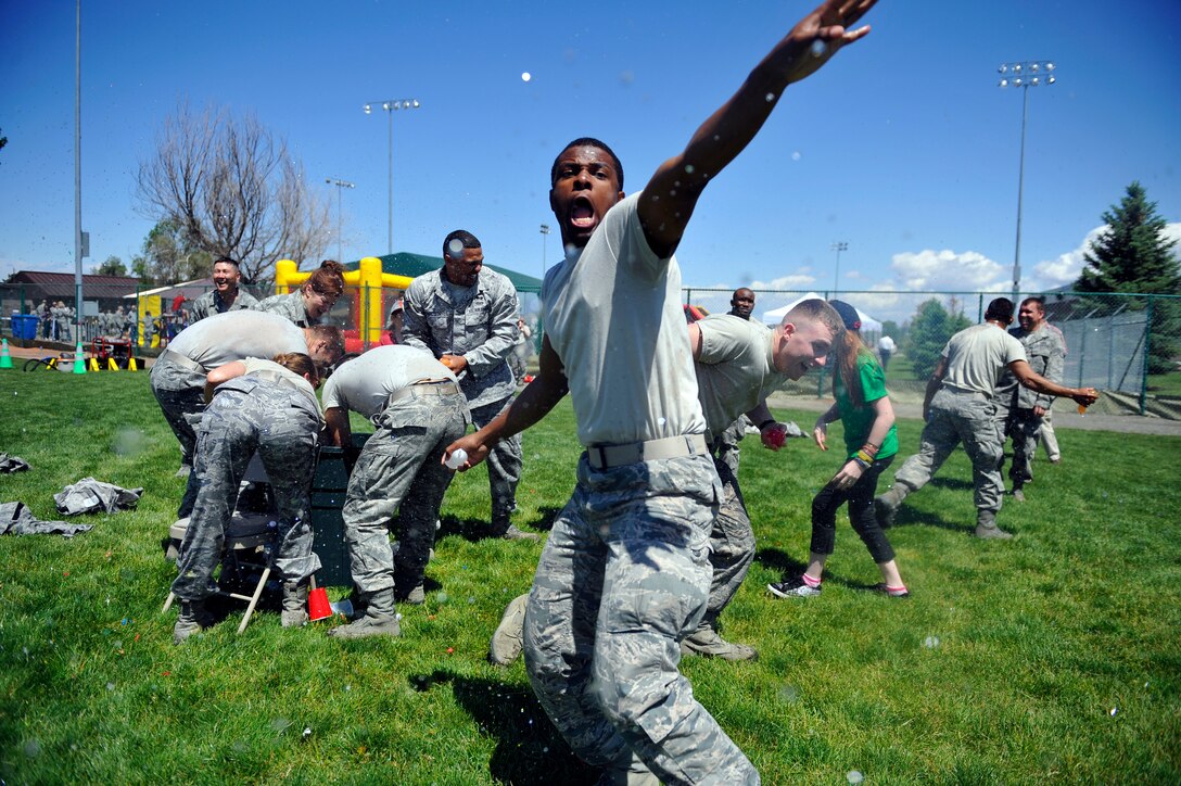 BUCKLEY AIR FORCE BASE, Colo. -- 460th Space Wing members cool off during a free-for-all, water balloon fight May 24, 2012. Celebrating an "Excellent" rating for the recent Operational Readiness Inspection, the 460th SW threw a celebration at the softball fields.   (U.S. Air Force photo by Staff Sgt. Kathrine McDowell)