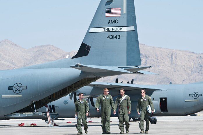 U.S. Air Force Weapons School students and evaluators walk from a C-130 Hercules on the flightline at Nellis Air Force Base, Nev., after participating in the Mobility Air Forces Exercise May 23, 2012 over the Nevada Test and Training Range. The students attended graduate-level instructor courses that provide the world's most advanced training in air, space and cyber weapons and tactics employment. (U.S. Air Force photo by Lawrence Crespo)