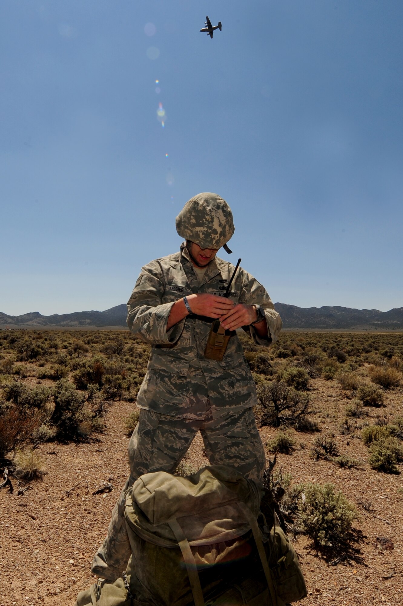 U.S. Air Force Staff Sgt. Nick Mosier, 820th RED HORSE Squadron explosive ordnance disposal craftsman, gathers his equipment after jumping out of a C-130 Hercules during a Mobility Air Forces Exercise May 23, 2012, at the Nevada Test and Training Range, Nev. Mosier, along with other EOD Airmen, cleared improvised explosive devices out of the area to allow a safe repair of the runway. (U.S. Air Force photo by Staff Sgt. William P.Coleman)
  

