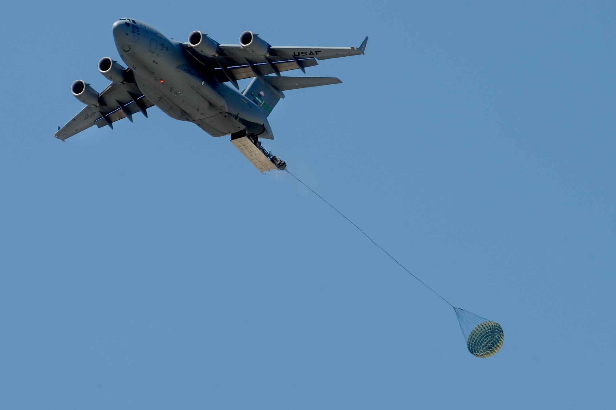 A C-17 Globemaster III from McChord Air Force Base, Wash. drops equipment used for a rapid runway repair during a Mobility Air Forces Exercise May 23, 2012, at the Nevada Test and Training Range. After all the equipment was dropped, airborne engineers from the 820th RED HORSE Squadron, Nellis Air Force Base, Nev., cleared and repaired a dirt runway. (U.S. Air Force photo by Staff Sgt. William P.Coleman)
  

