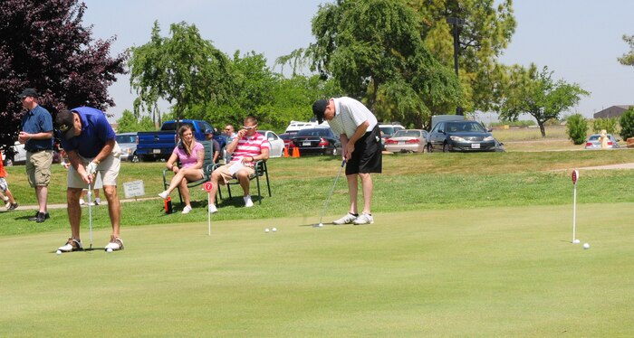 Members of Team Beale practice putting during the Beale Liaison Committee golf tournament at the Coyote Run Golf Course here May 18. Members of the winning group included: Joey Brown, Chris White. Donald Payne and Shawn O'leary. (U.S. Air Force photo by Senior Airman Allen Pollard/Released)   
