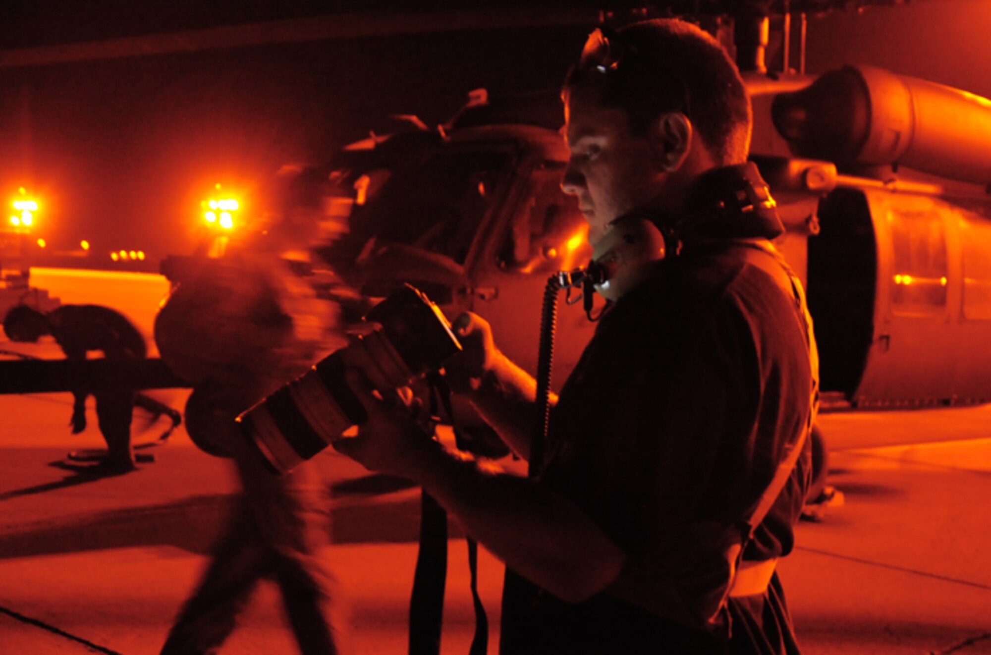 Mike Killian, ARES Institute and AmericaSpace reporter/photographer covers a 920th Rescue Wing rocket launch mission May 22 at Patrick Air Force Base, Fla. He photographs Airmen as they prep through the night for a range clearing mission aboard an HH-60G Pave Hawk helicopter to support a milestone rocket launch. Killian flew with the Airmen several hours prior to a Falcon 9 rocket launch securing the Eastern Range for the first ever commercial mission to the International Space Station. (U.S. Air Force photo/Capt. Cathleen Snow)