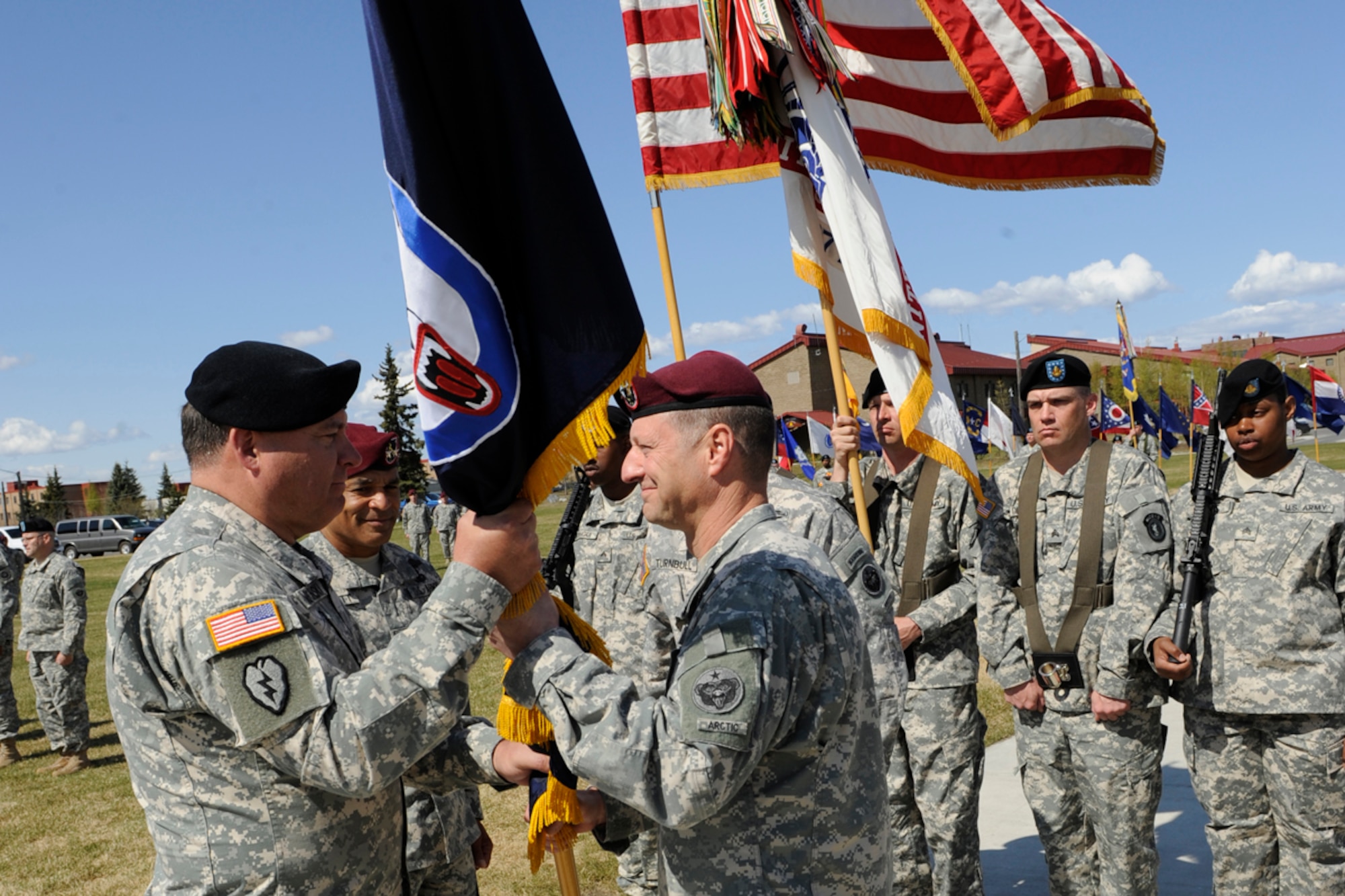 JOINT BASE ELMENDORF-RICHARDSON,Alaska -- Army Lt. Gen. Francis Wiercinski, commanding general, U.S. Army Pacific, accepts the U.S. Army Alaska guidon from Maj. Gen. Raymond Palumbo as Palumbo relinquishes command of USARAK during the  change of command ceremony. Palumbo who will be transferring to the Pentagon.  (USAF Photo by Steven White/JBER PA)