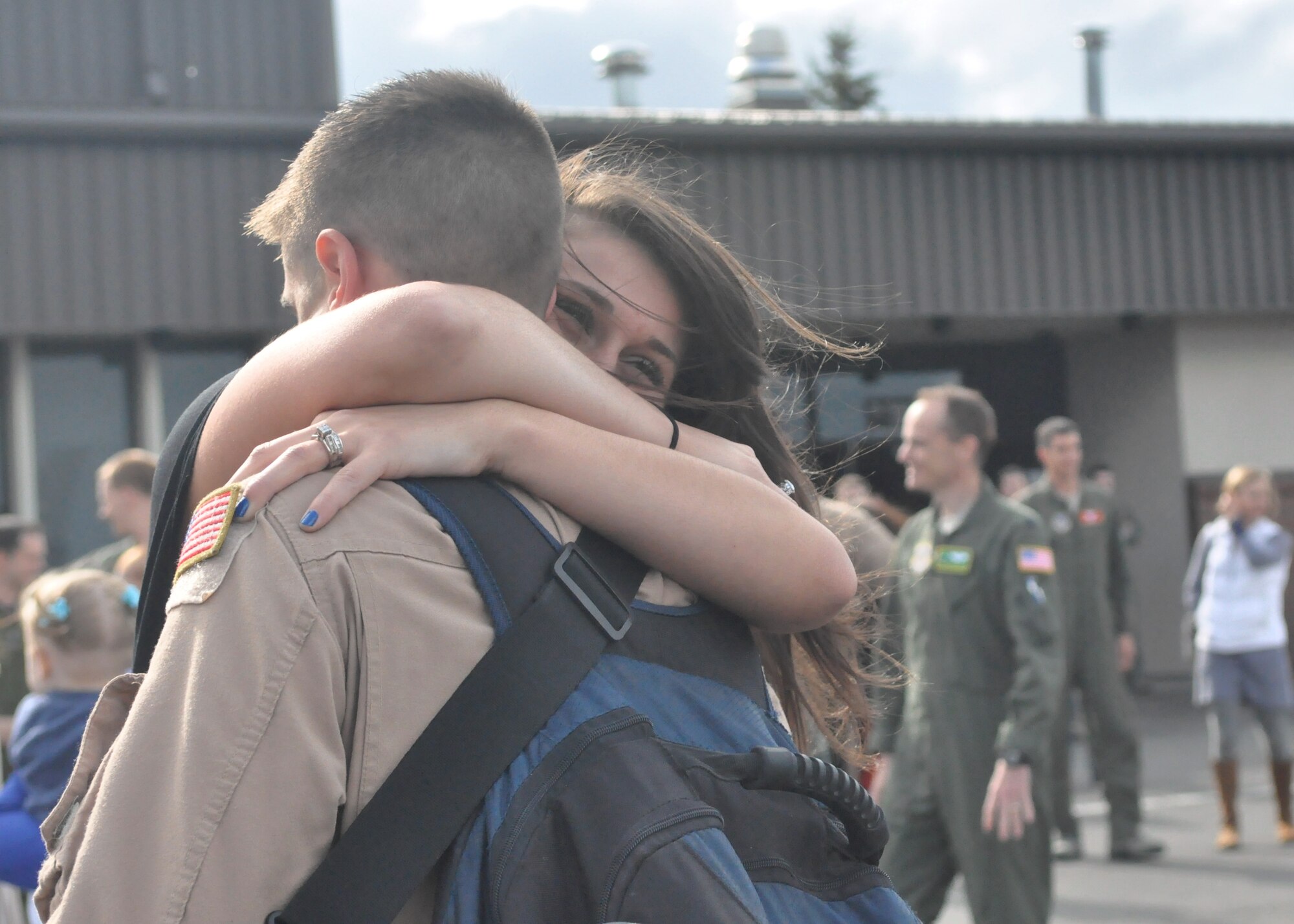 Nichole Hertzog hugs her husband, Senior Airman Tyler Hertzog, 8th Airlift Squadron loadmaster, after returning from a 75-day deployment May 23, 2012, at Joint Base Lewis-McChord, Wash. More than 90 Airmen from the 10th AS deployed in support of Operations Enduring Freedom and New Dawn. They were accompanied by Airmen from the 446th Airlift Wing and others from Elmendorf Air Force Base, Alaska, and Joint Base Pearl Harbor-Hickam, Hawaii. (U.S. Air Force photo/Senior Airman Leah Young)