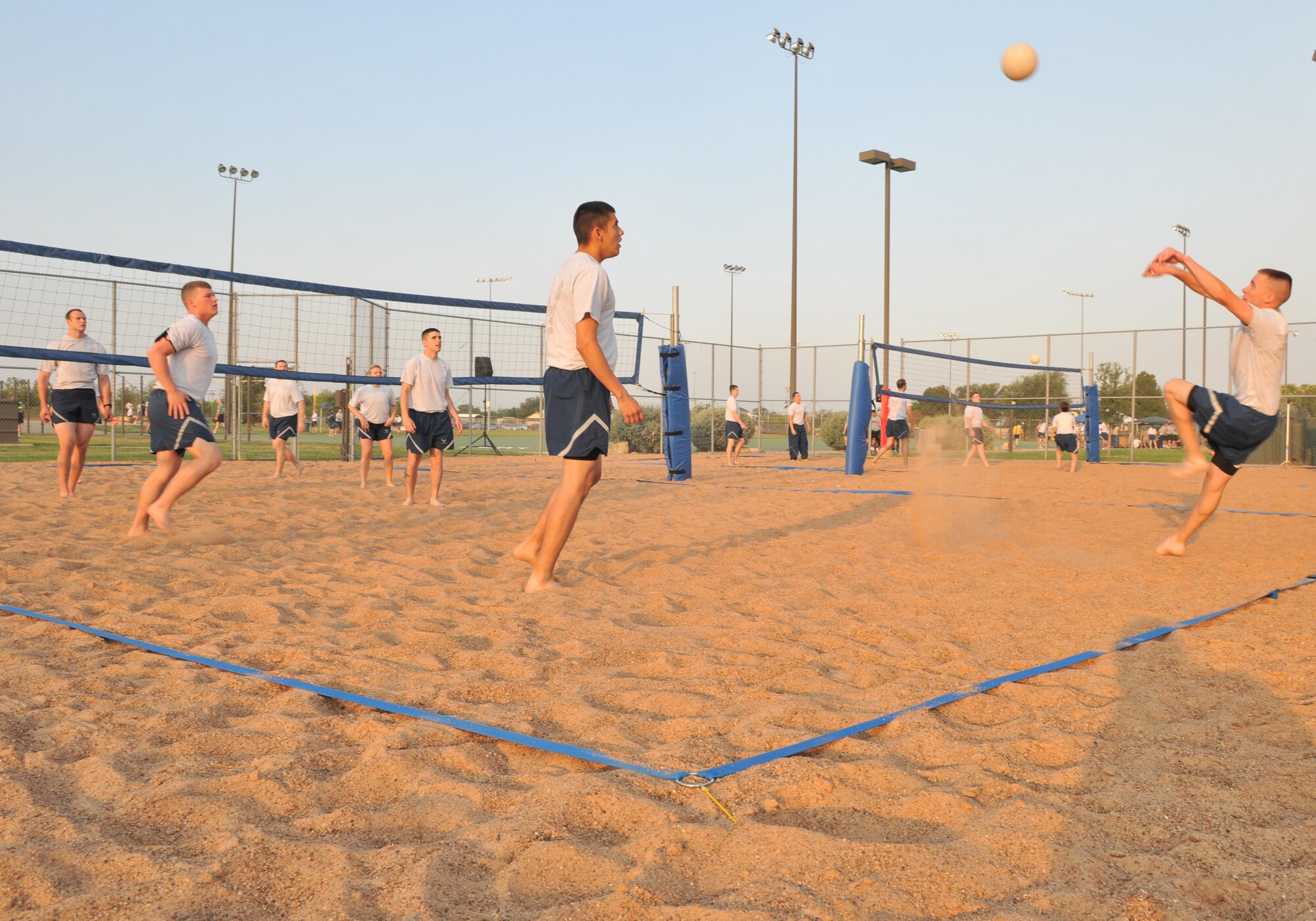 GOODFELLOW AIR FORCE BASE, Texas -- A 312th Training Squadron firefighter student sets up the ball for his teammates during 4-on-4 volleyball against 315th TRS intelligence students May 24. (U.S. Air Force photo/ Staff Sgt. Tong Duong)