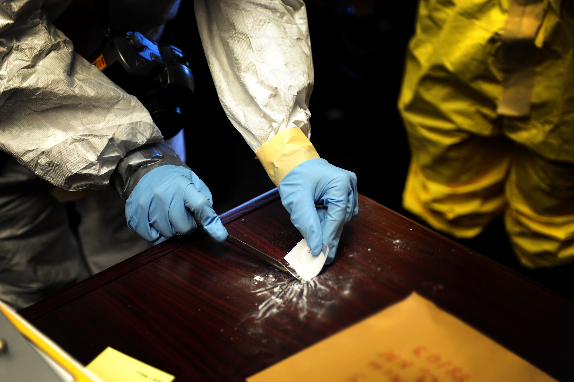 U.S. Air Force Staff Sgt. Rachael Walter, 27th Special Operations Aerospace Medical Squadron, collects a sample of a potential contaminant for testing during a base-wide exercise at Cannon Air Force Base, N.M., May 23, 2012. The exercise tested Cannon Air Commandos' abilities to respond to potential real-life incidents. (U.S. Air Force photo by Airman 1st Class Eboni Reece)
