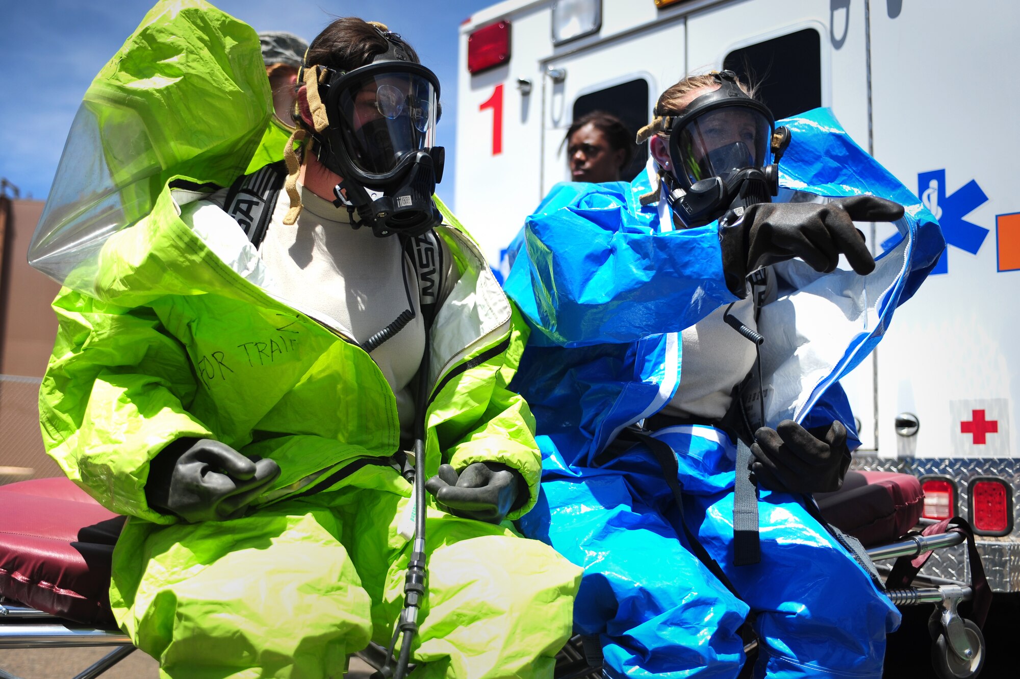 U.S. Air Force Senior Airman Renee Malsom, 27th Special Operations Civil Engineer Squadron emergency management, and Staff Sgt. Tara Sheaib, 27th Special Operations Aerospace Medicine Squadron bioenvironmental engineer technician, rest on a stretcher before entering a potentially hazardous area during a base-wide exercise at Cannon Air Force Base, N.M., May 23, 2012. Once inside, the team conducted tests on a substance leak from a simulated suspicious package. (U.S. Air Force photo by Airman 1st Class Eboni Reece)