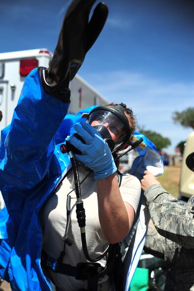 U.S. Air Force Staff Sgt. Tara Sheaib, 27th Special Operations Aerospace Medicine Squadron bioenvironmental engineer technician, gears up with a Level-A suit before entering a potentially hazardous area during a base-wide exercise at Cannon Air Force Base, N.M., May 23, 2012. Once inside, the team conducted tests on a substance leak from a simulated suspicious package. (U.S. Air Force photo by Airman 1st Class Eboni Reece)
