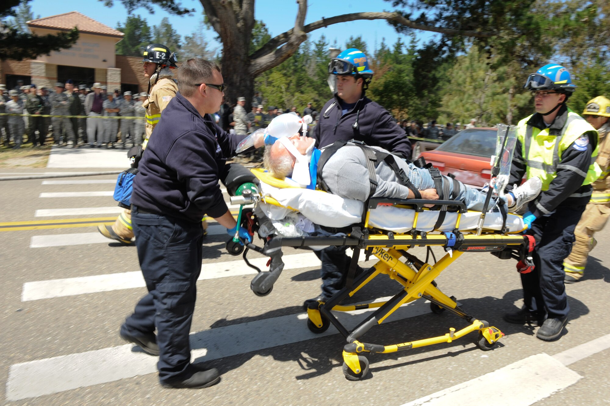 VANDENBERG AIR FORCE BASE, Calif. -- Team V emergency personnel respond to a staged drunk driving accident in front of the Base Fitness Center here Thursday, May 24, 2012. Airmen Against Drunk Driving teamed up with Vandenberg first responders to give base personnel a firsthand experience with the immediate consequences of impaired driving. This event concluded a week of outreach activities to raise awareness on the importance of safety during the Critical Days of Summer. (U.S. Air Force photo/Staff Sgt. Levi Riendeau)