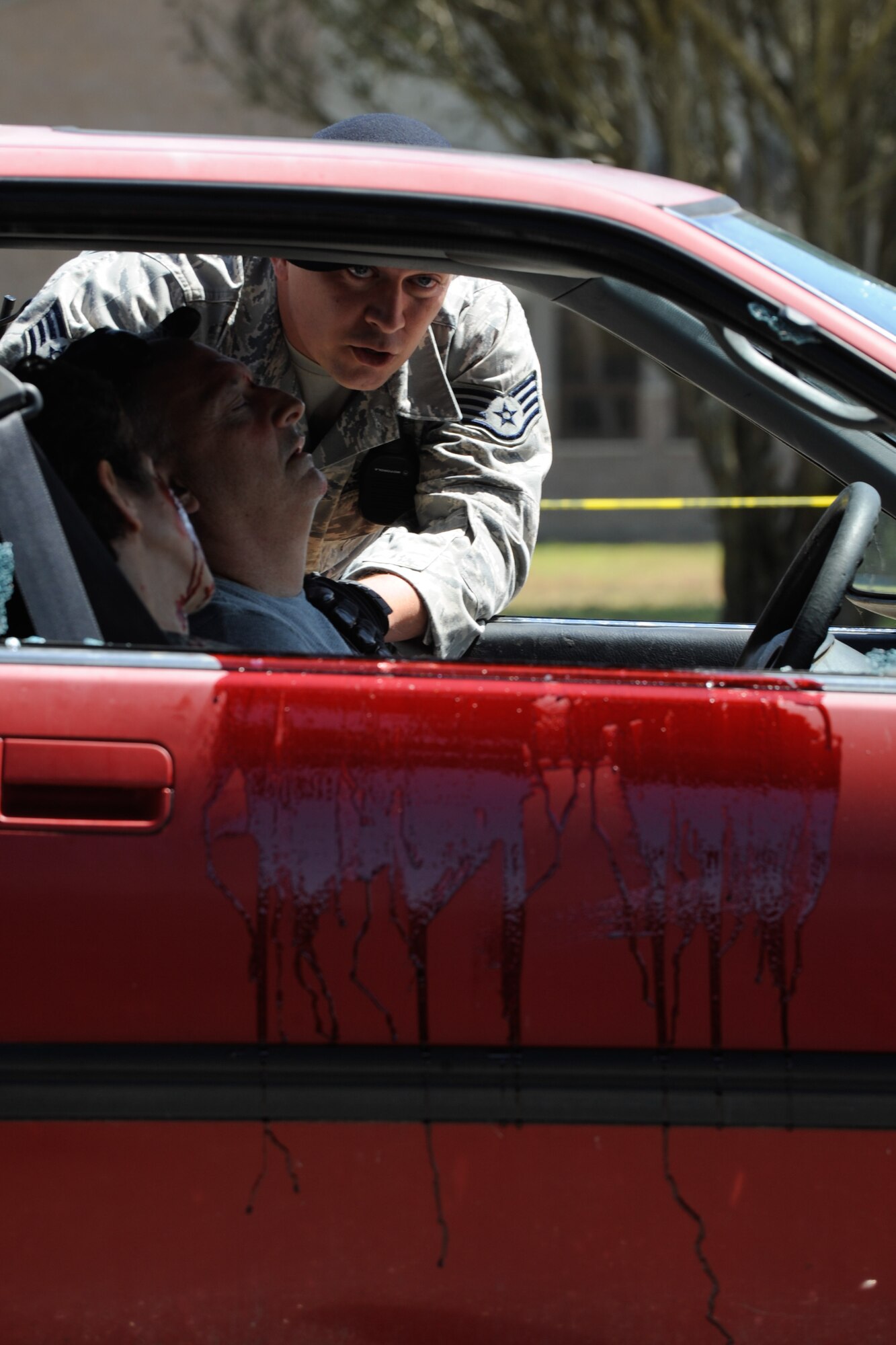 VANDENBERG AIR FORCE BASE, Calif. -- Team V emergency personnel respond to a staged drunk driving accident in front of the Base Fitness Center here Thursday, May 24, 2012. Airmen Against Drunk Driving teamed up with Vandenberg first responders to give base personnel a firsthand experience with the immediate consequences of impaired driving. This event concluded a week of outreach activities to raise awareness on the importance of safety during the Critical Days of Summer. (U.S. Air Force photo/Staff Sgt. Levi Riendeau)
