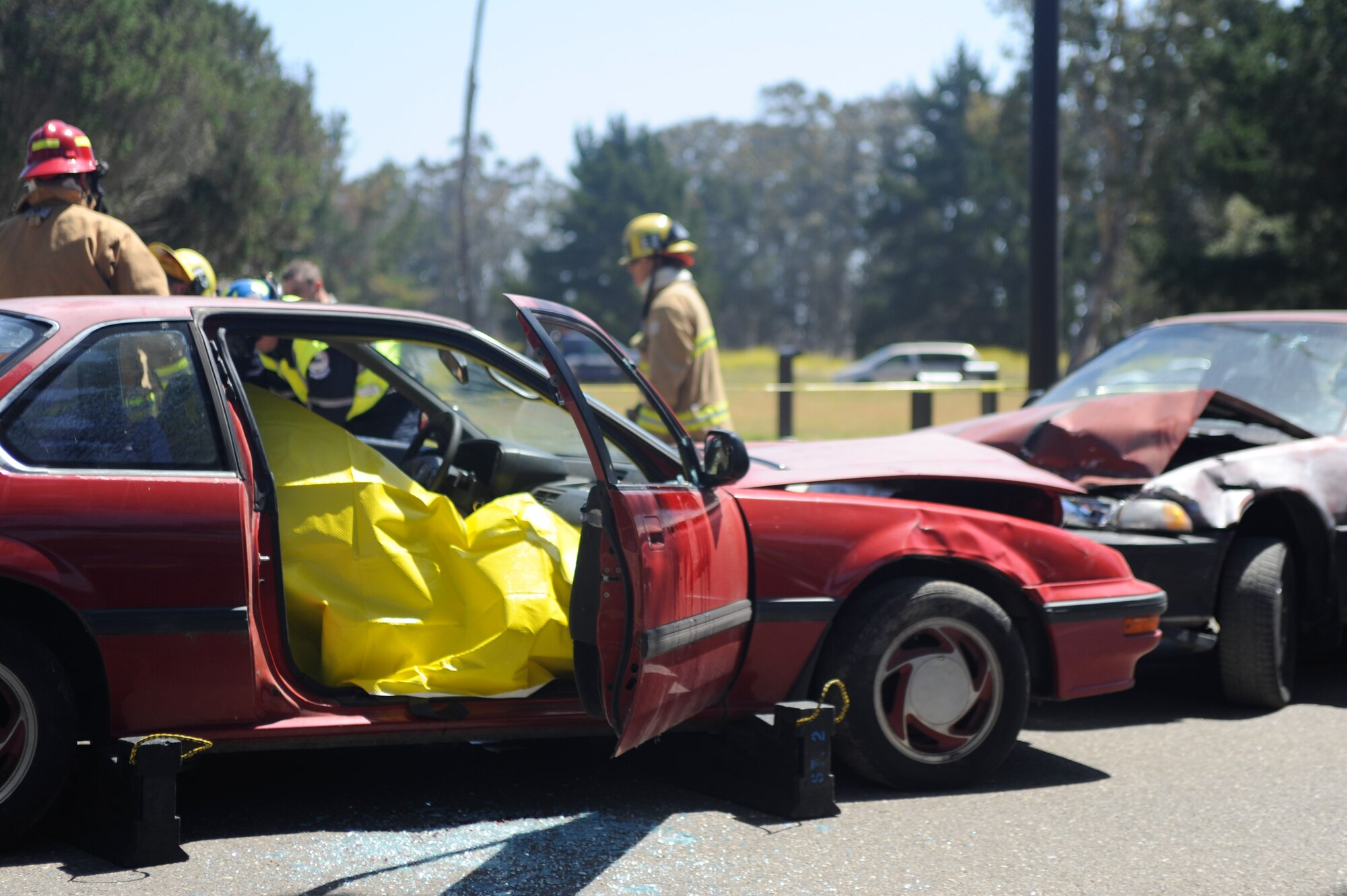 VANDENBERG AIR FORCE BASE, Calif. -- Team V emergency personnel respond to a staged drunk driving accident in front of the Base Fitness Center here Thursday, May 24, 2012. Airmen Against Drunk Driving teamed up with Vandenberg first responders to give base personnel a firsthand experience with the immediate consequences of impaired driving. This event concluded a week of outreach activities to raise awareness on the importance of safety during the Critical Days of Summer. (U.S. Air Force photo/Staff Sgt. Andrew Satran)
