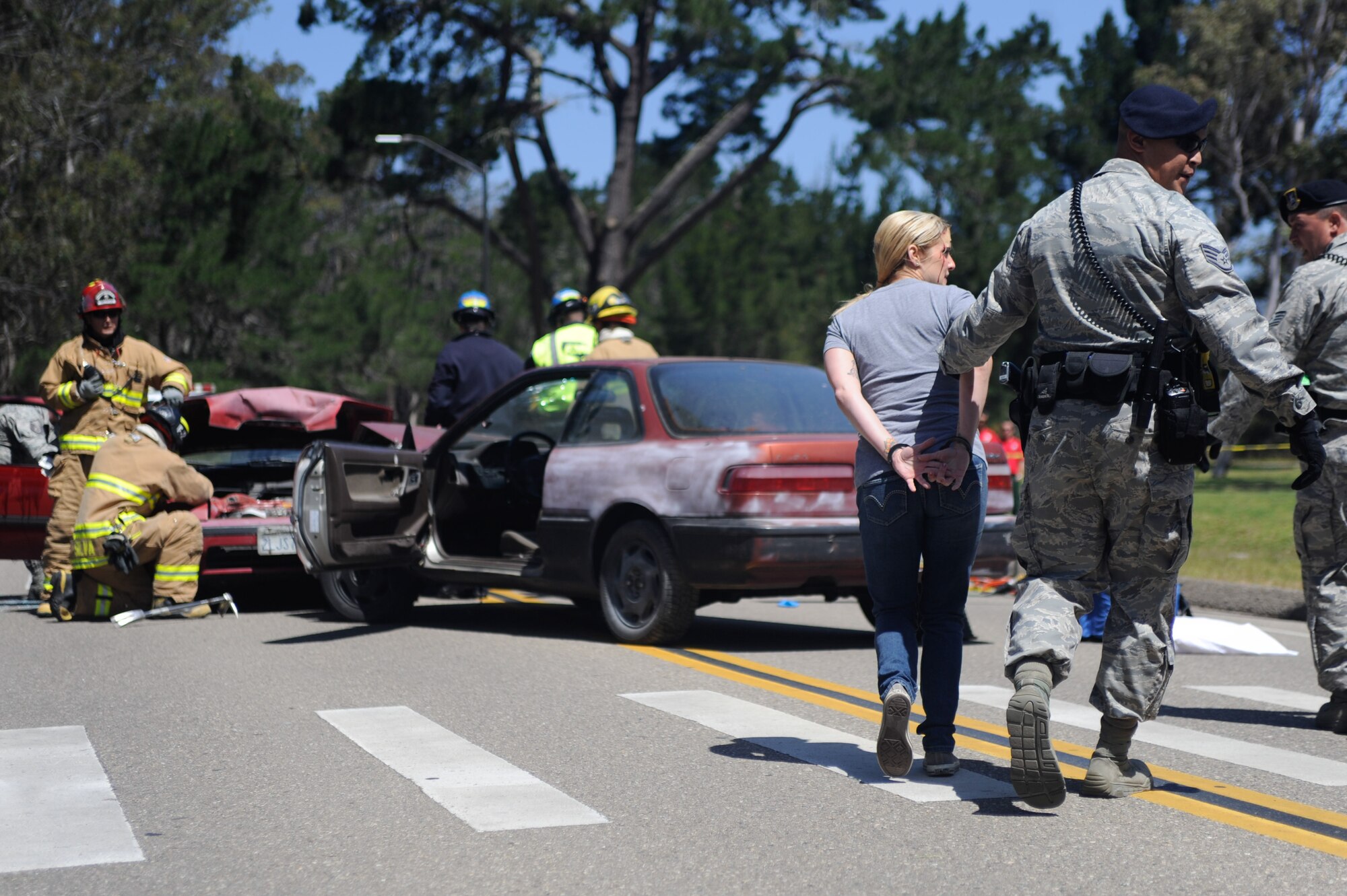 VANDENBERG AIR FORCE BASE, Calif. -- Team V emergency personnel respond to a staged drunk driving accident in front of the Base Fitness Center here Thursday, May 24, 2012. Airmen Against Drunk Driving teamed up with Vandenberg first responders to give base personnel a firsthand experience with the immediate consequences of impaired driving. This event concluded a week of outreach activities to raise awareness on the importance of safety during the Critical Days of Summer. (U.S. Air Force photo/Staff Sgt. Andrew Satran)