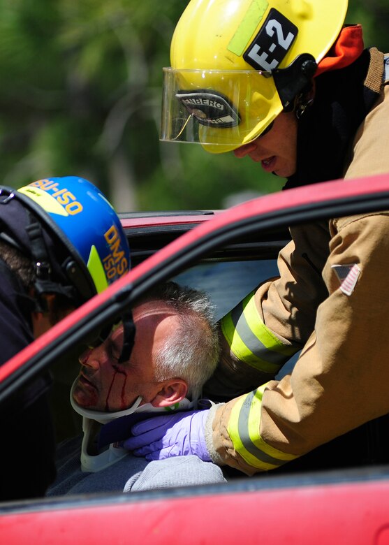 VANDENBERG AIR FORCE BASE, Calif. -- Team V emergency personnel respond to a staged drunk driving accident in front of the Base Fitness Center here Thursday, May 24, 2012. Airmen Against Drunk Driving teamed up with Vandenberg first responders to give base personnel a firsthand experience with the immediate consequences of impaired driving. This event concluded a week of outreach activities to raise awareness on the importance of safety during the Critical Days of Summer. (U.S. Air Force photo/Michael Peterson)