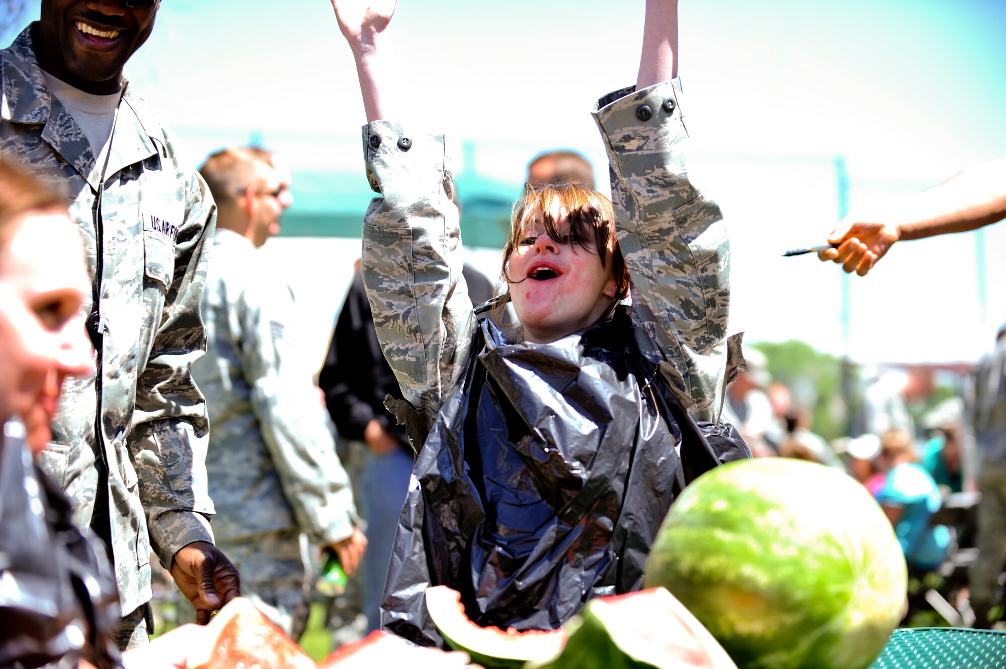BUCKLEY AIR FORCE BASE, Colo. -- Airman 1st Class Danielle Keister,460th Security Forces Squadron pass and ID technician, celebrates as the winner of a watermelon eating contest May 24, 2012. Members of Team Buckley participated in a day of activities celebrating their excellent rating during their recent Operational Readiness Inspection. (U.S. Air Force Photo/ Senior Airman Paul Labbe)
