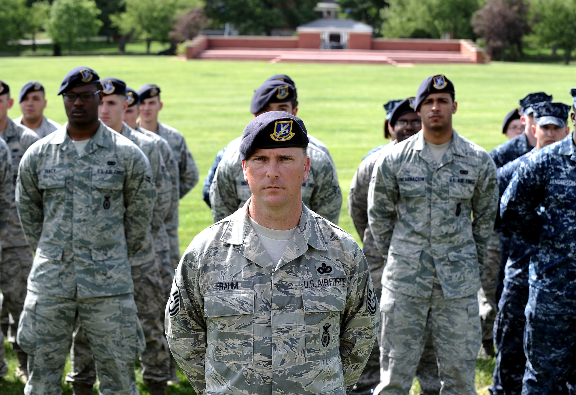 U.S. Air Force Master Sgt.  Chad Frahm, 55th Security Forces Squadron, stands at the front of a formation while attending the 55th SFS retreat held at the Parade Grounds as part of National Police Week May 17 at Offutt Air Force Base, Neb. The military retreat consisted of several speeches in memoriam to both security forces members as well as the Office of Special Investigations.  (U.S. Air Force photo by Josh Plueger)