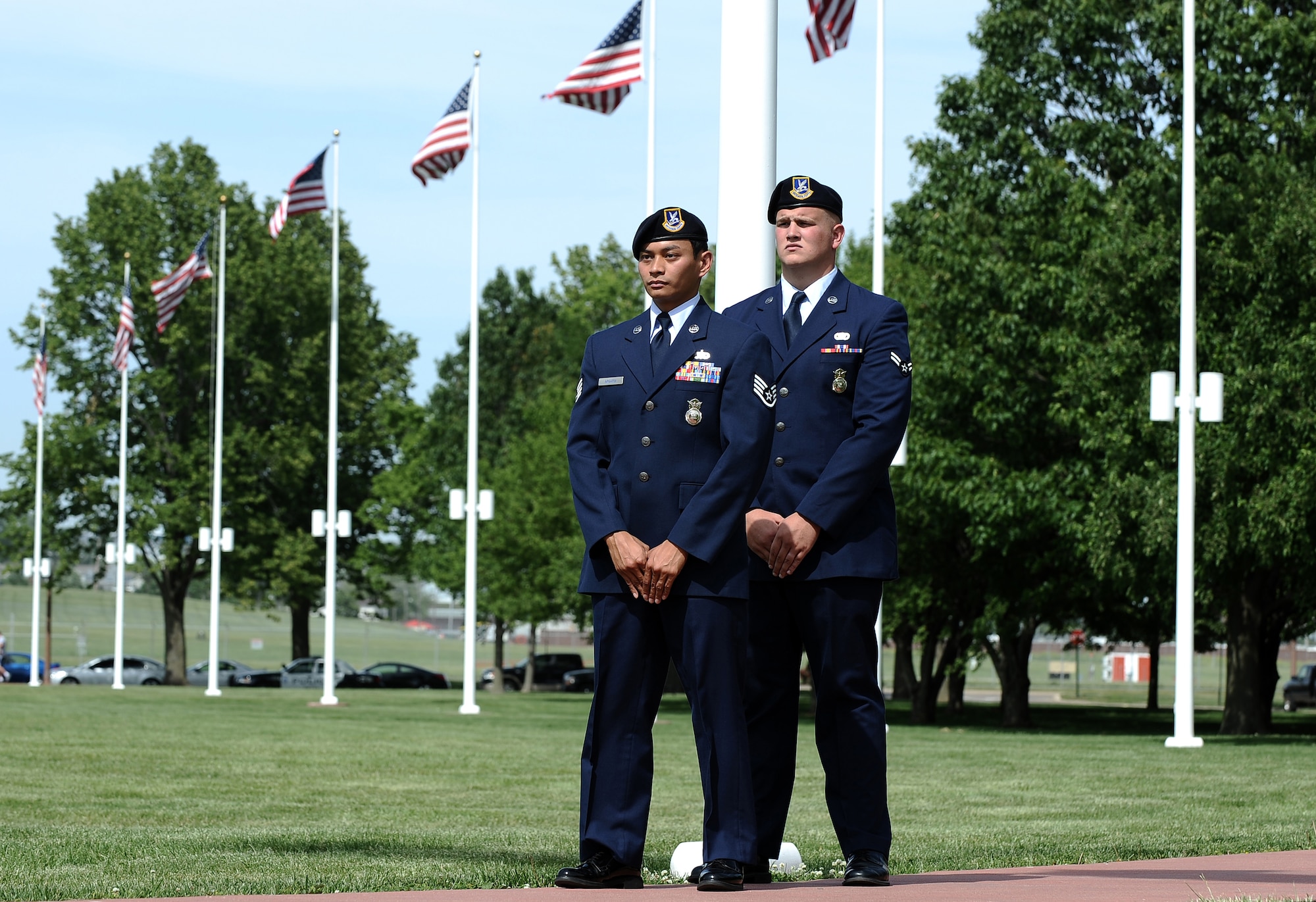 U.S. Air Force Staff Sgt. Ernie Argarin, a 55th Security Forces Squadron member with the National Airborne Operations Center, along with U.S. Air Force Airman 1st Class Lance Hillenga, 55th SFS, stand ready to perform the flag security detail at the 55th SFS retreat held during National Police Week at the Parade Grounds May 17 at Offutt Air Force Base, Neb. The military retreat signals the end of the duty day and pays respect to the flag.  (U.S. Air Force photo by Josh Plueger)