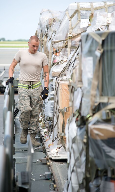 Senior Airman Brandon Dodd, ramp services specialist with the 436th Aerial Port Squadron, locks pallets on a “60K Tunner” K-loader May 24, 2012, at Dover Air Force Base, Del. The 436th APS is in charge of processing cargo that is then shipped across the world. (U.S. Air Force photo by Adrian R. Rowan)
